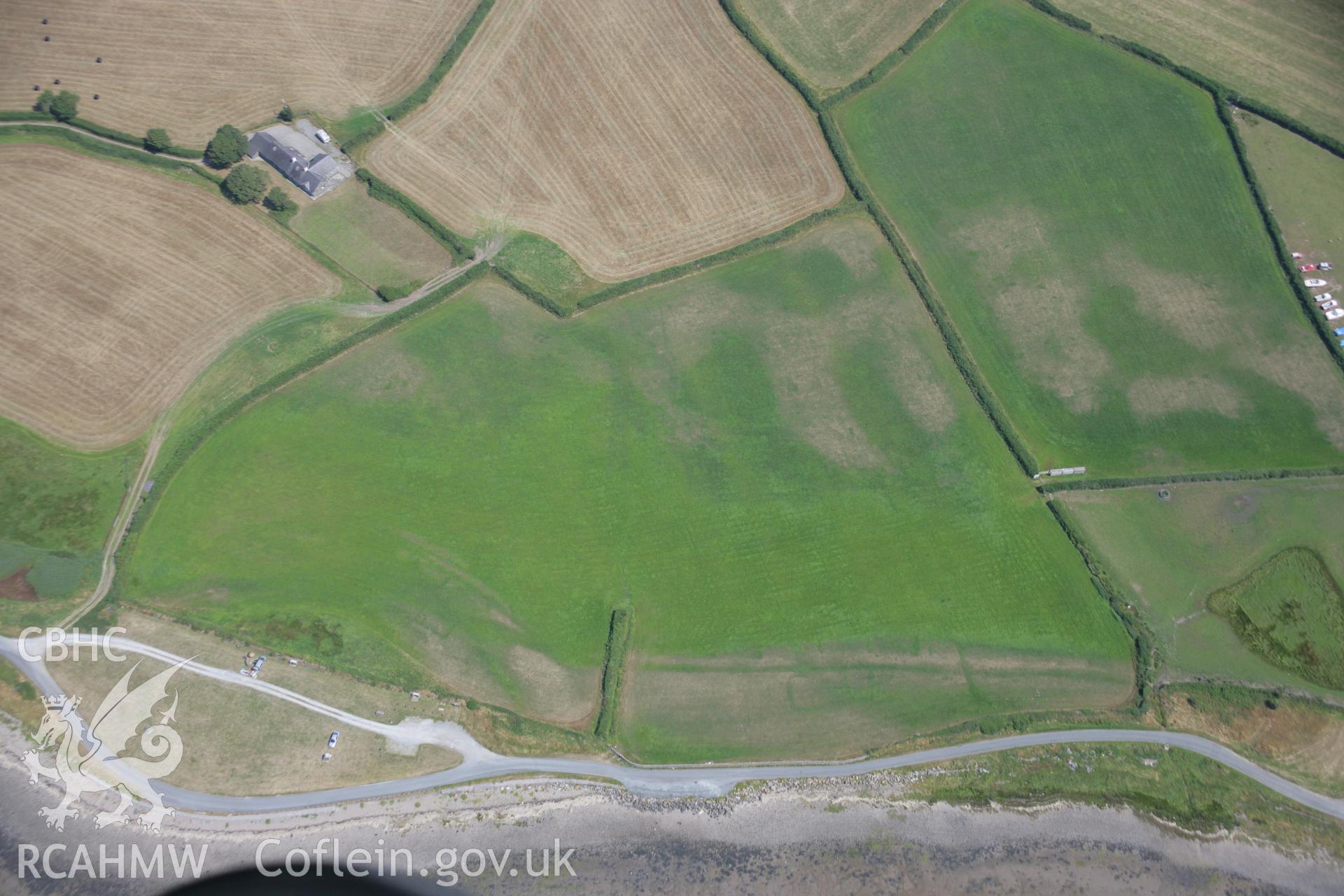 RCAHMW colour oblique aerial photograph of cropmarks of rectangular buildings at Glan y Mor . Taken on 18 July 2006 by Toby Driver.