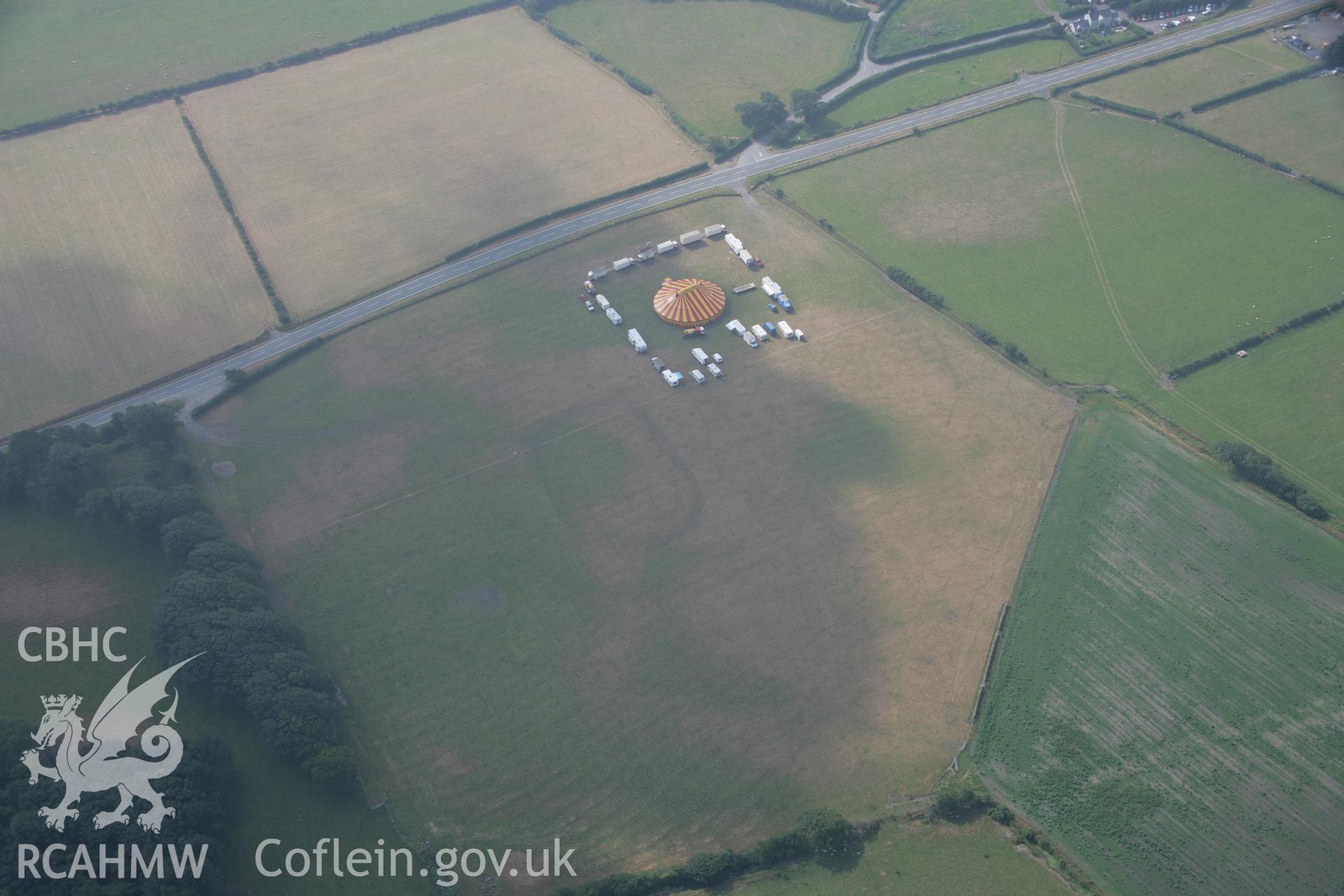 RCAHMW colour oblique aerial photograph of cropmark features north of Croes Faen possibly representing early Medieval Barrows. Taken on 21 July 2006 by Toby Driver.
