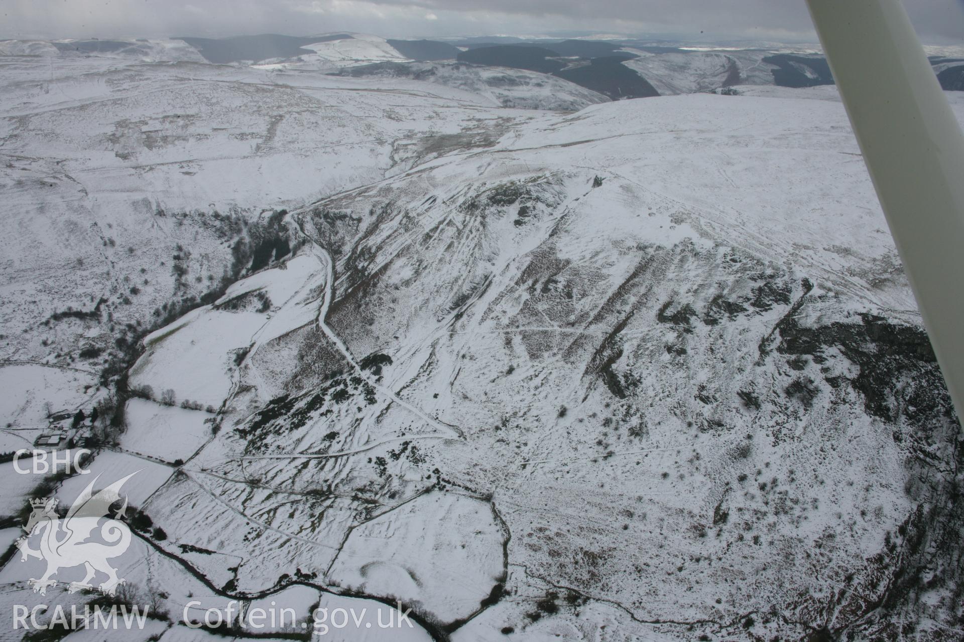 RCAHMW colour oblique aerial photograph of Craig-y-Mwyn Lead Mine, Llanrhaeadr-Ym-Mochnant, from the north under snow. Taken on 06 March 2006 by Toby Driver.