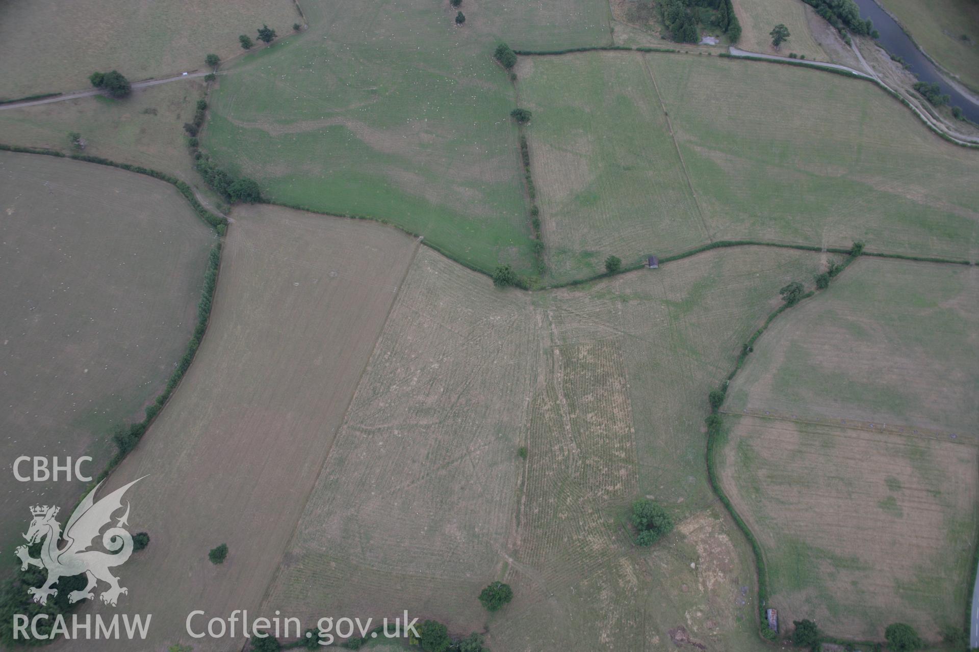 RCAHMW colour oblique aerial photograph showing parchmarks in grass at Llwyn-y-Brain Roman Fort. Taken on 14 August 2006 by Toby Driver.