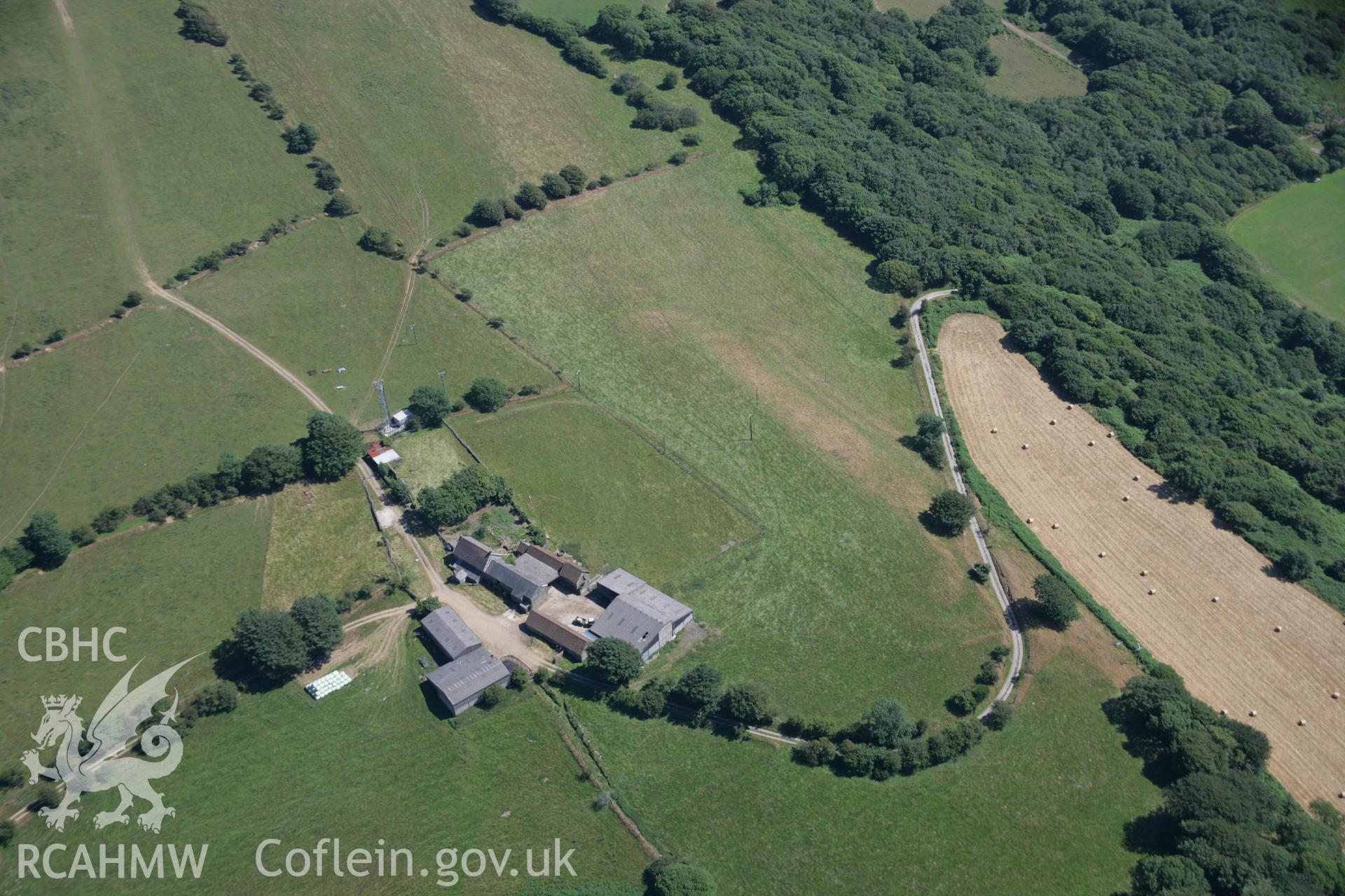 RCAHMW colour oblique aerial photograph of Ton Mawr Farm, showing earthworks that may be an indication of a hillfort. Taken on 24 July 2006 by Toby Driver.