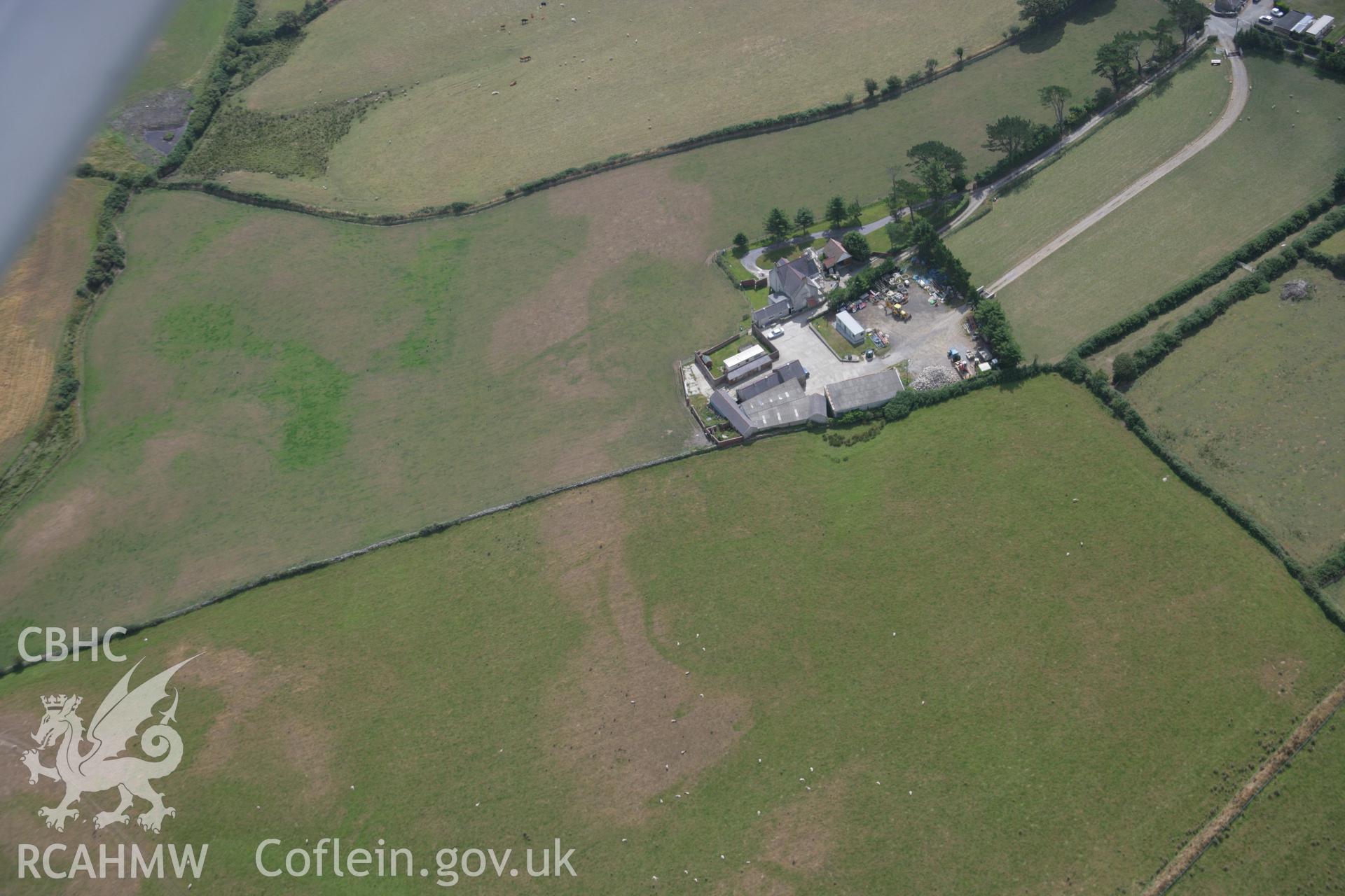 RCAHMW colour oblique aerial photograph of Pwll Parc Cropmark Enclosure from the west. Taken on 03 August 2006 by Toby Driver.