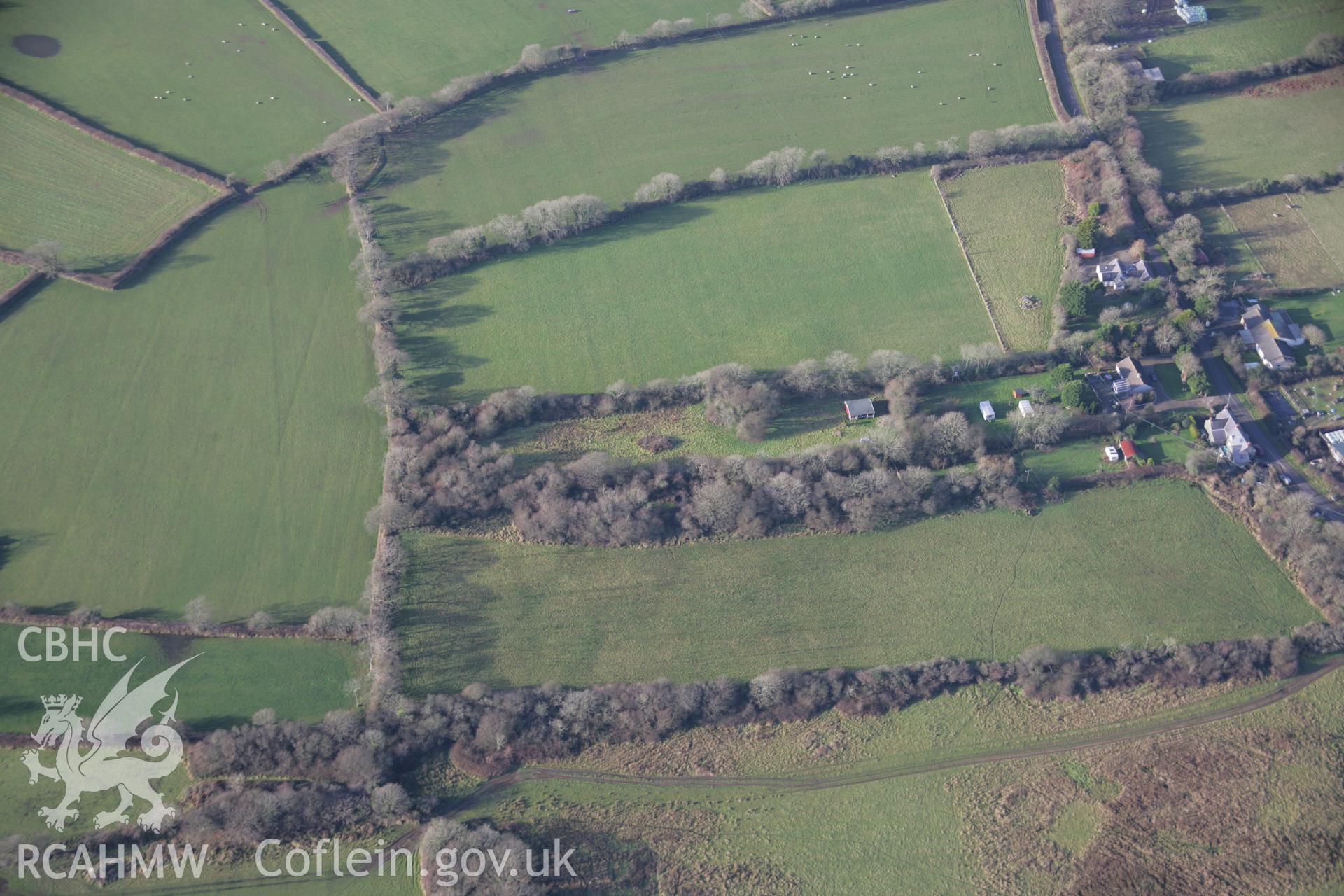 RCAHMW colour oblique aerial photograph of a round barrow south of Rosemary Lane from the east. Taken on 11 January 2006 by Toby Driver.