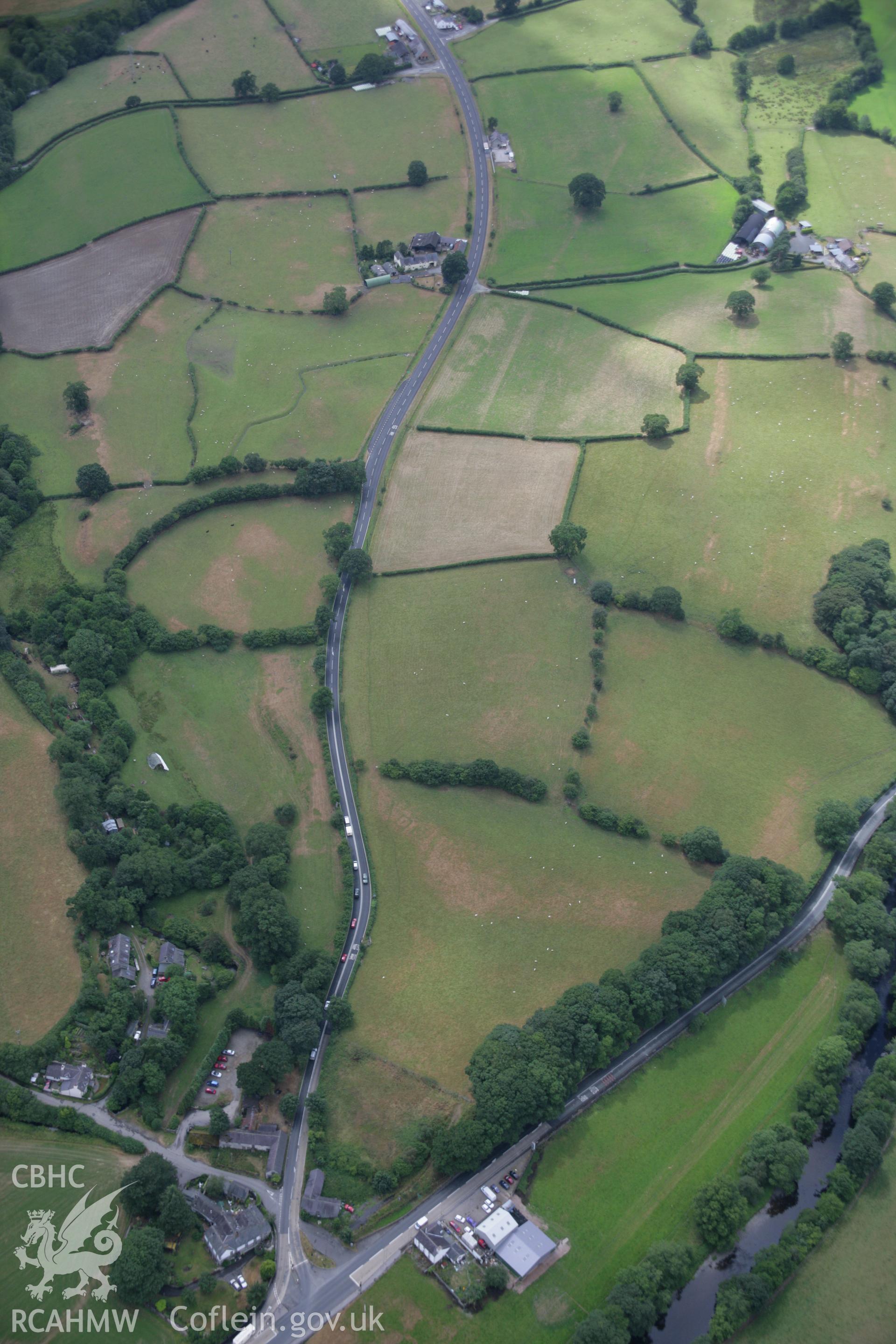 RCAHMW colour oblique aerial photograph of the Roman road between Four Crosses and Druid at Bryncoch. Taken on 31 July 2006 by Toby Driver