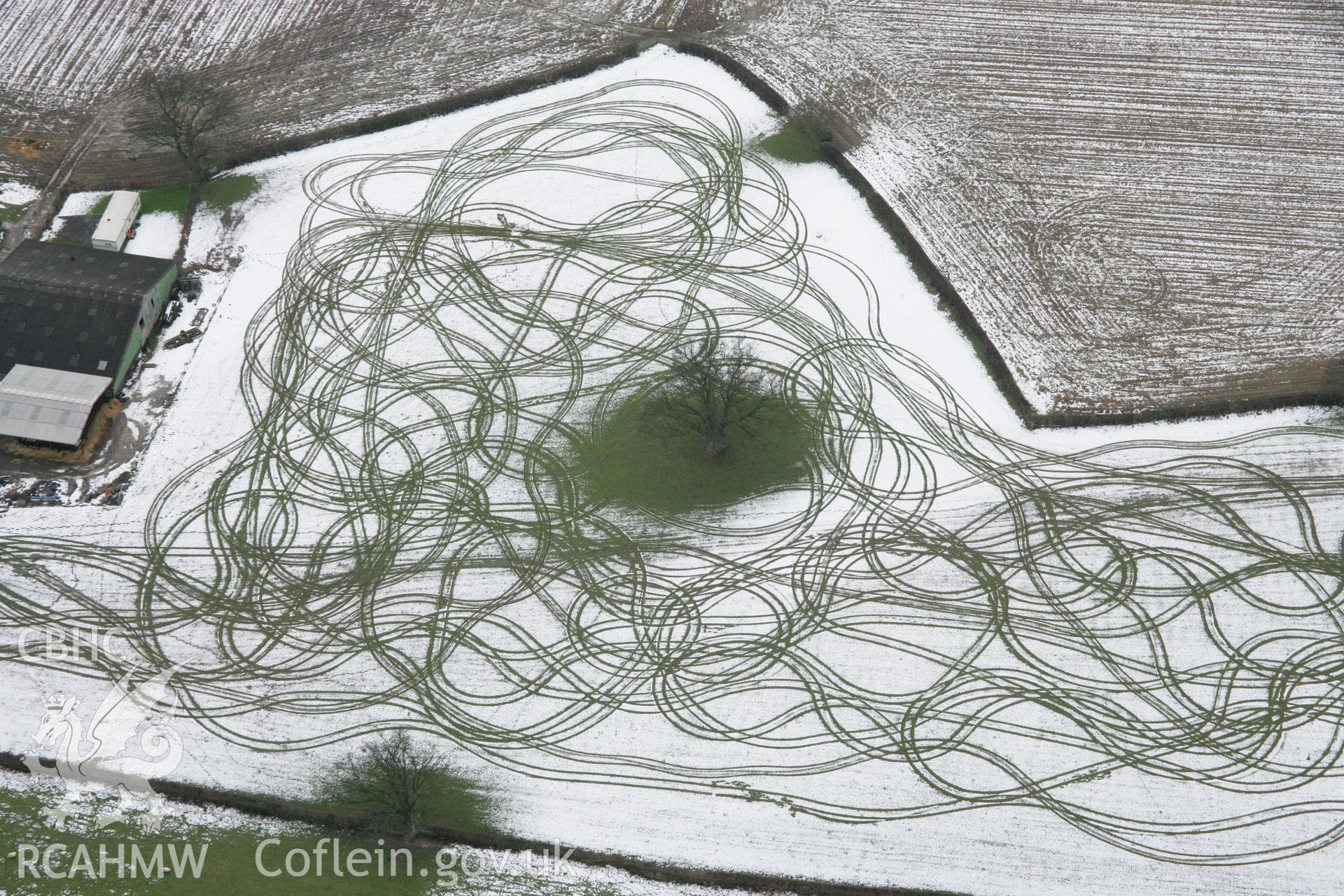 RCAHMW colour oblique aerial photograph of Tyddyn Isaf showing patterns in the snow to the north-west of the farm. Viewed from the north-east. Taken on 06 March 2006 by Toby Driver.
