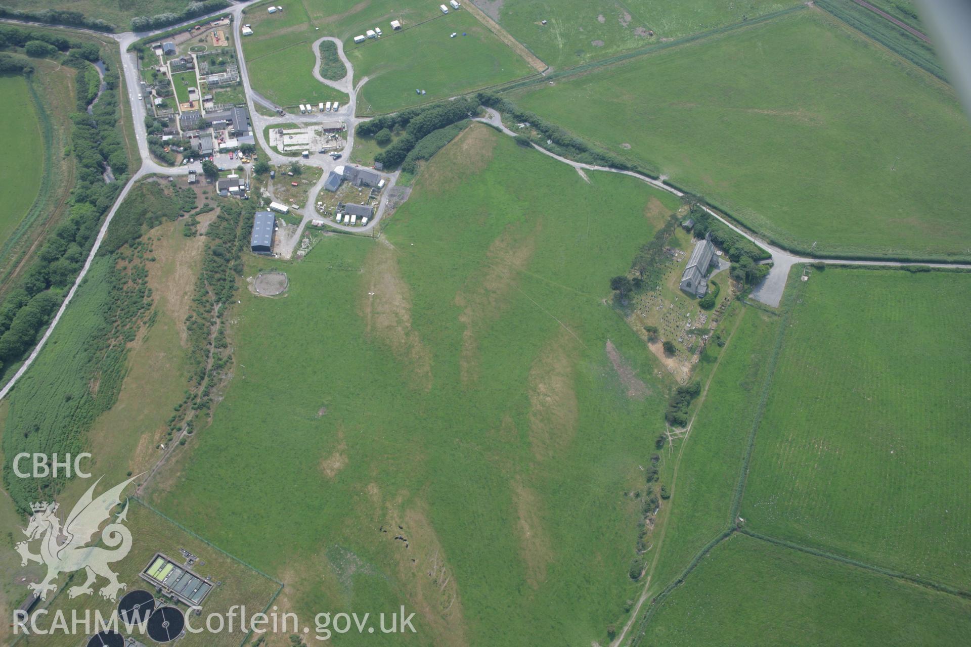 RCAHMW colour oblique aerial photograph of St Matthews Parish Church, Ynysfergi. Taken on 04 July 2006 by Toby Driver.