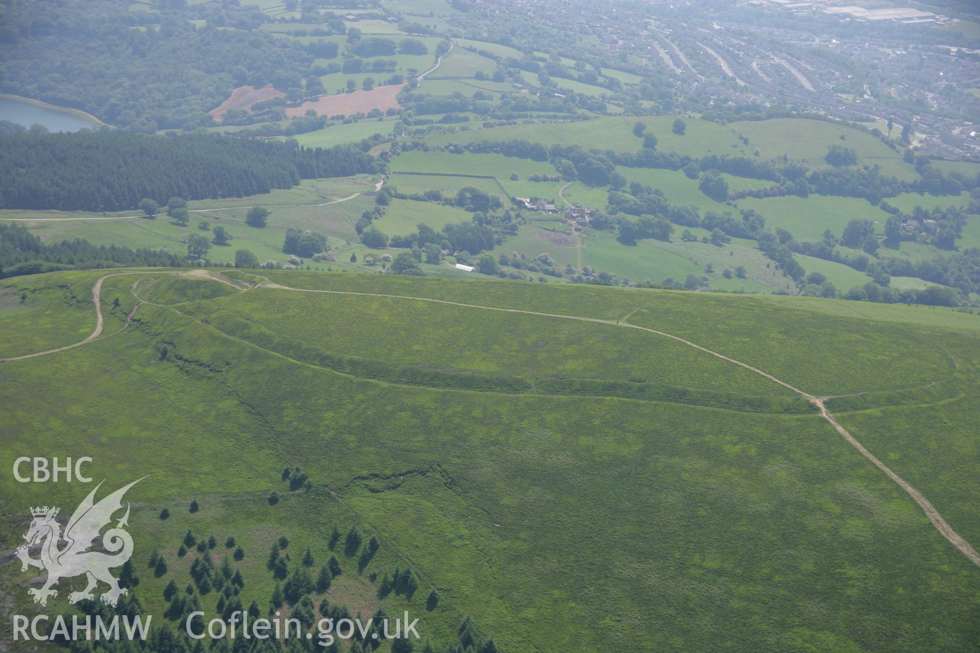 RCAHMW colour oblique aerial photograph of Twmbarlwm Castle and possible hillfort from the north. Taken on 09 June 2006 by Toby Driver.