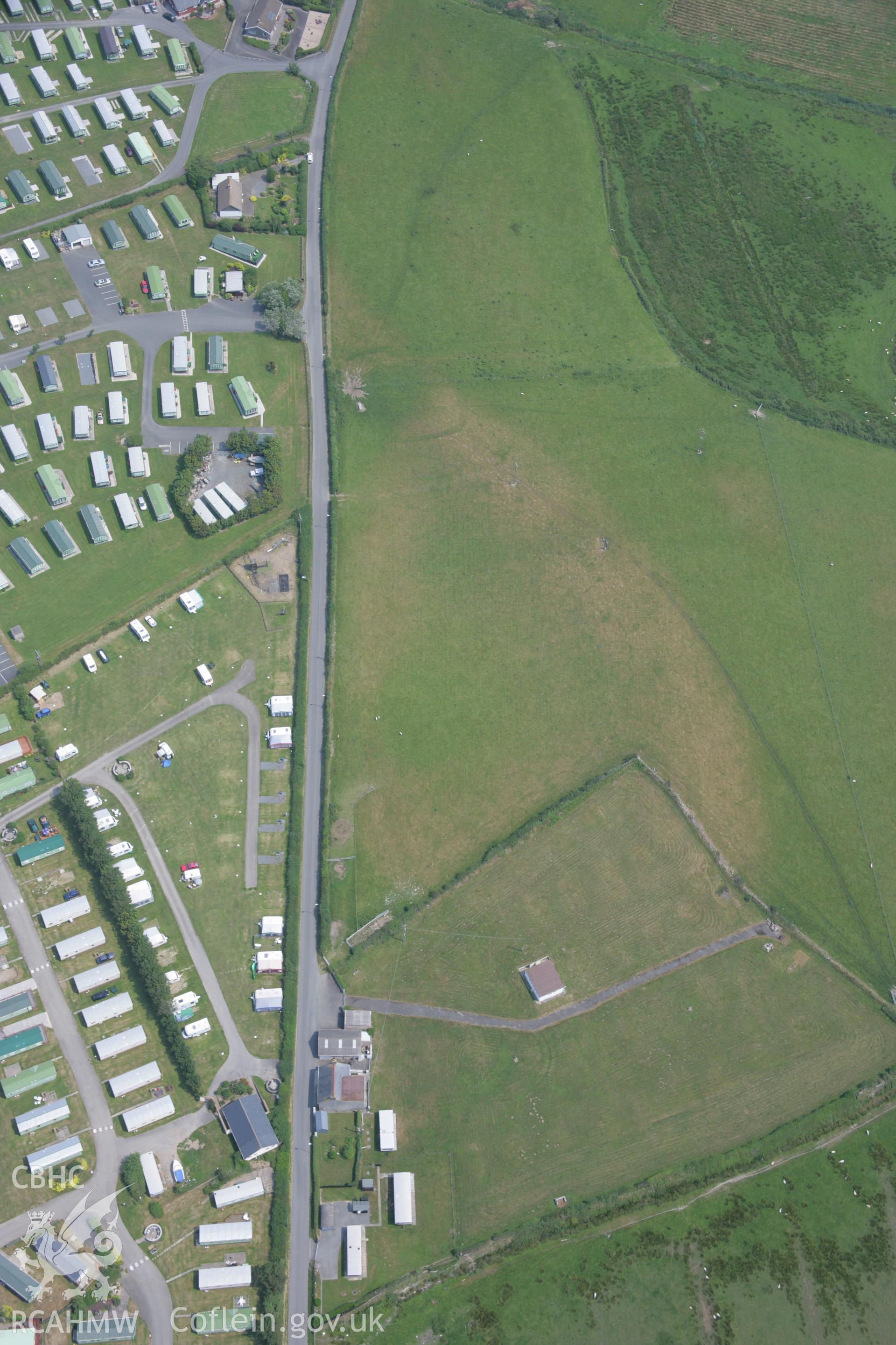 RCAHMW colour oblique aerial photograph of Glan-y-Mor Enclosure. Taken on 04 July 2006 by Toby Driver.