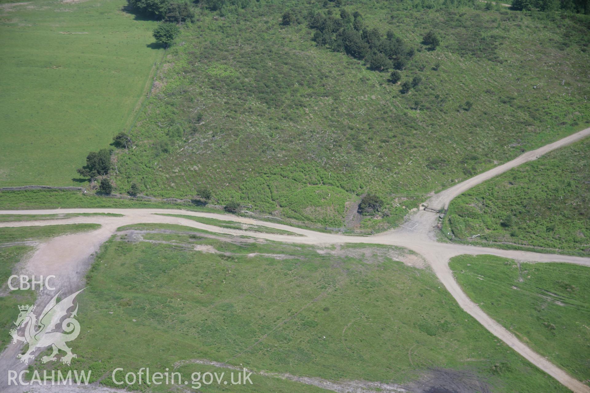 RCAHMW colour oblique aerial photograph of Twyn Cae-Hugh Round Barrow from the south-west. Taken on 09 June 2006 by Toby Driver.