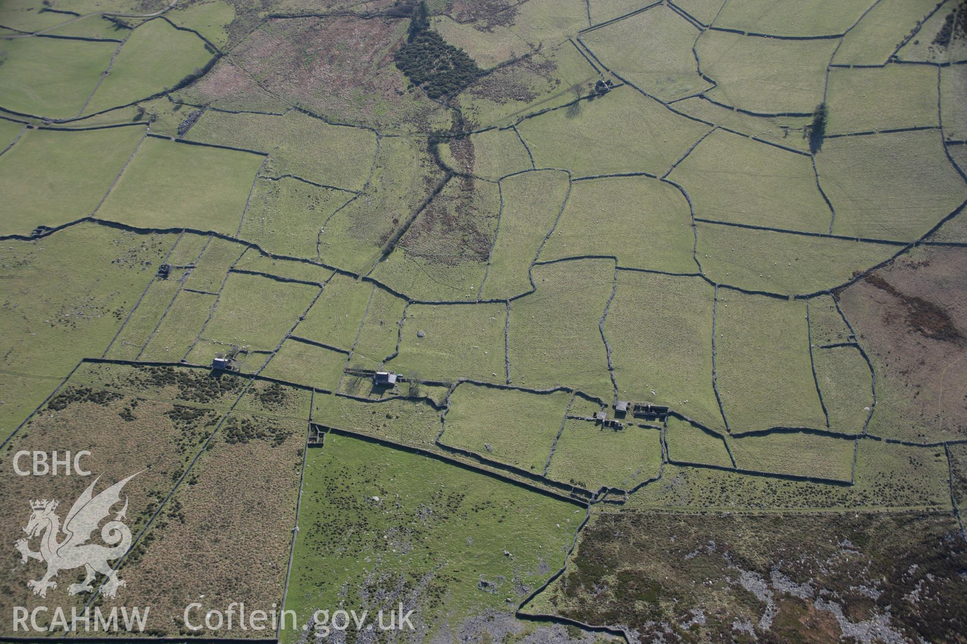 RCAHMW colour oblique aerial photograph of Pen-y-Bwlch, deserted farming landscape with hut group, viewed from the north-east. Taken on 09 February 2006 by Toby Driver.