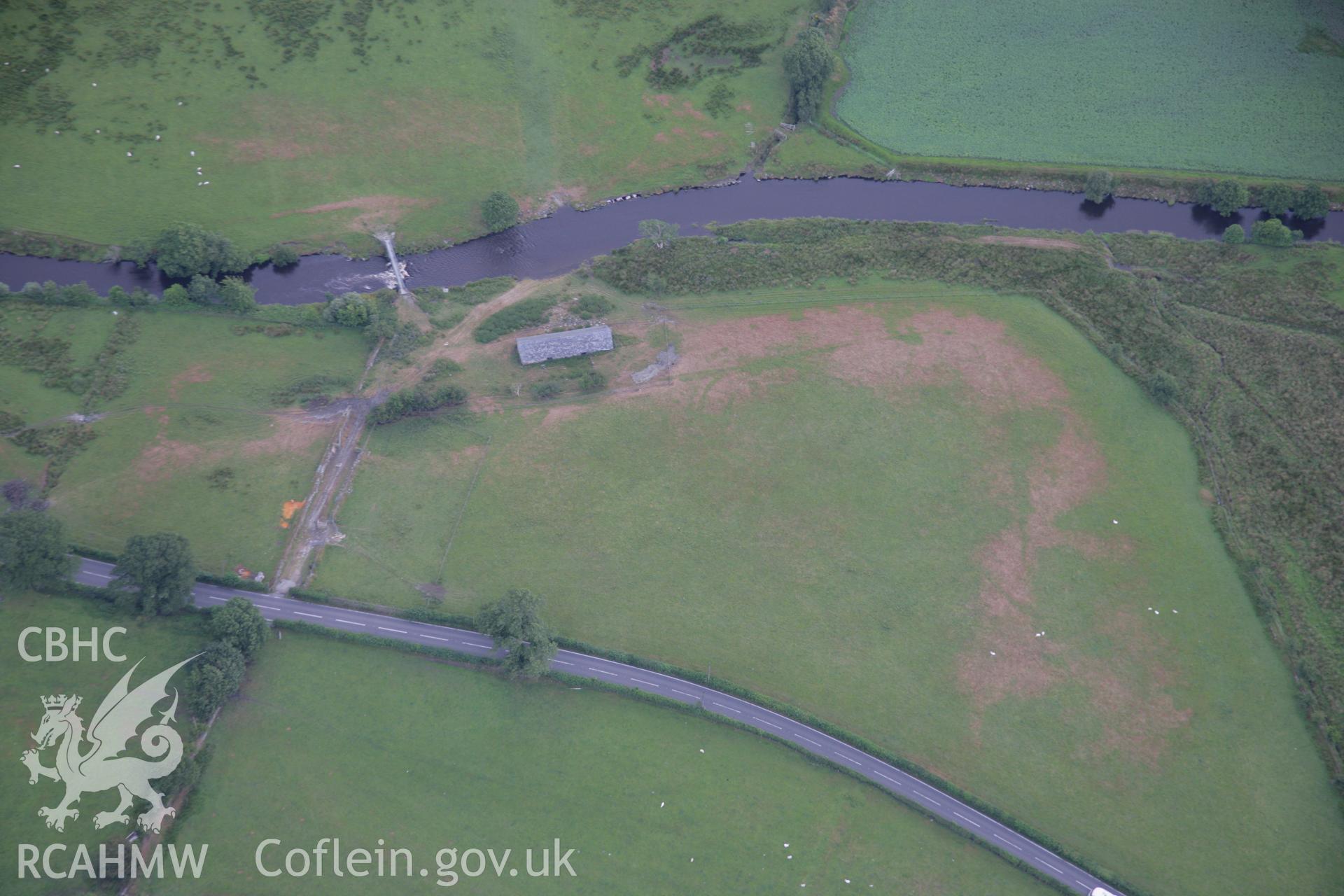 RCAHMW colour oblique aerial photograph of a parchmark complex including a square ditched feature south of Caer Gai. Taken on 31 July 2006 by Toby Driver.
