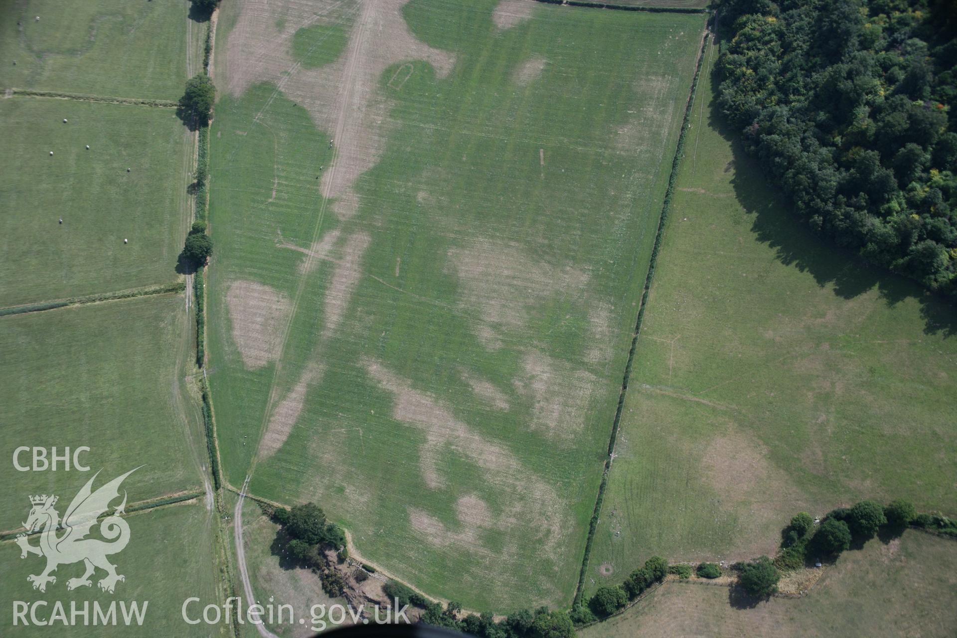 RCAHMW colour oblique aerial photograph of Llwydfaen Medieval Township, general view from north with parchmarks of church and building foundations, taken on 14/08/2006 by Toby Driver.