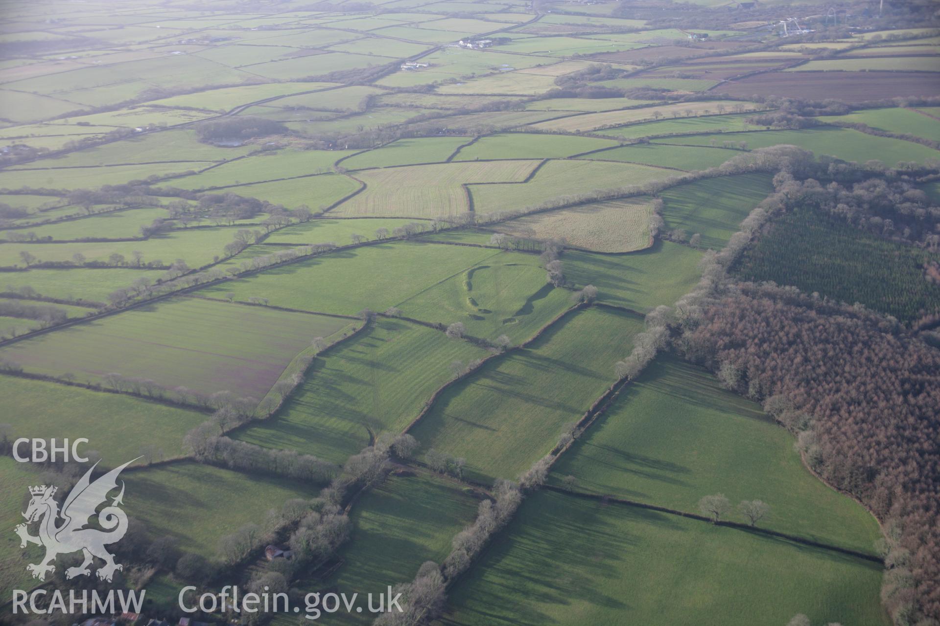 RCAHMW colour oblique aerial photograph of Molleston Back Hillfort Enclosure, in long landscape viewed from the east. Taken on 11 January 2006 by Toby Driver.