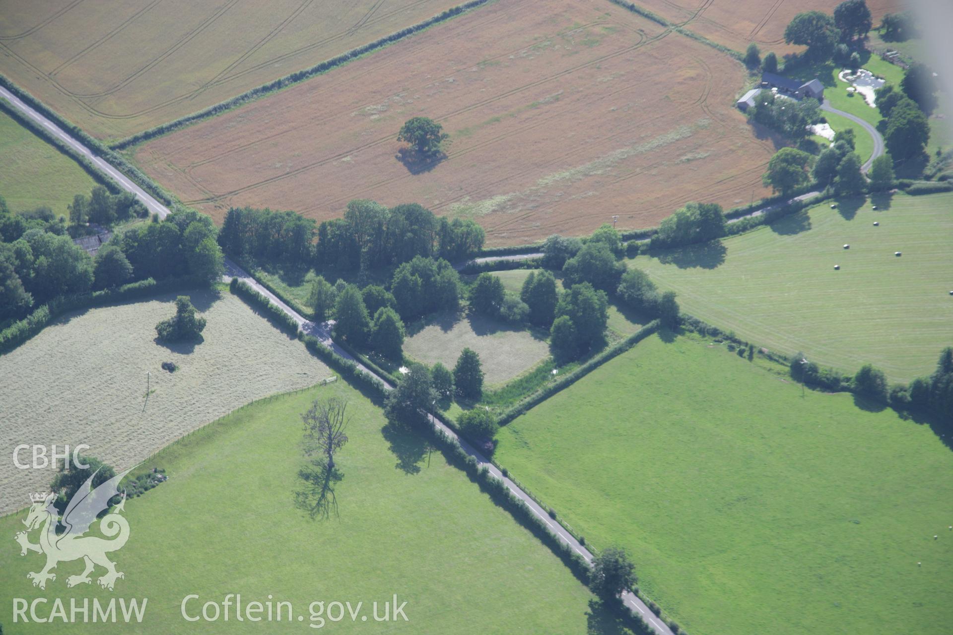 RCAHMW colour oblique aerial photograph of Hen Gwrt Moated Site, Llantilio Crossenny. Taken on 13 July 2006 by Toby Driver.