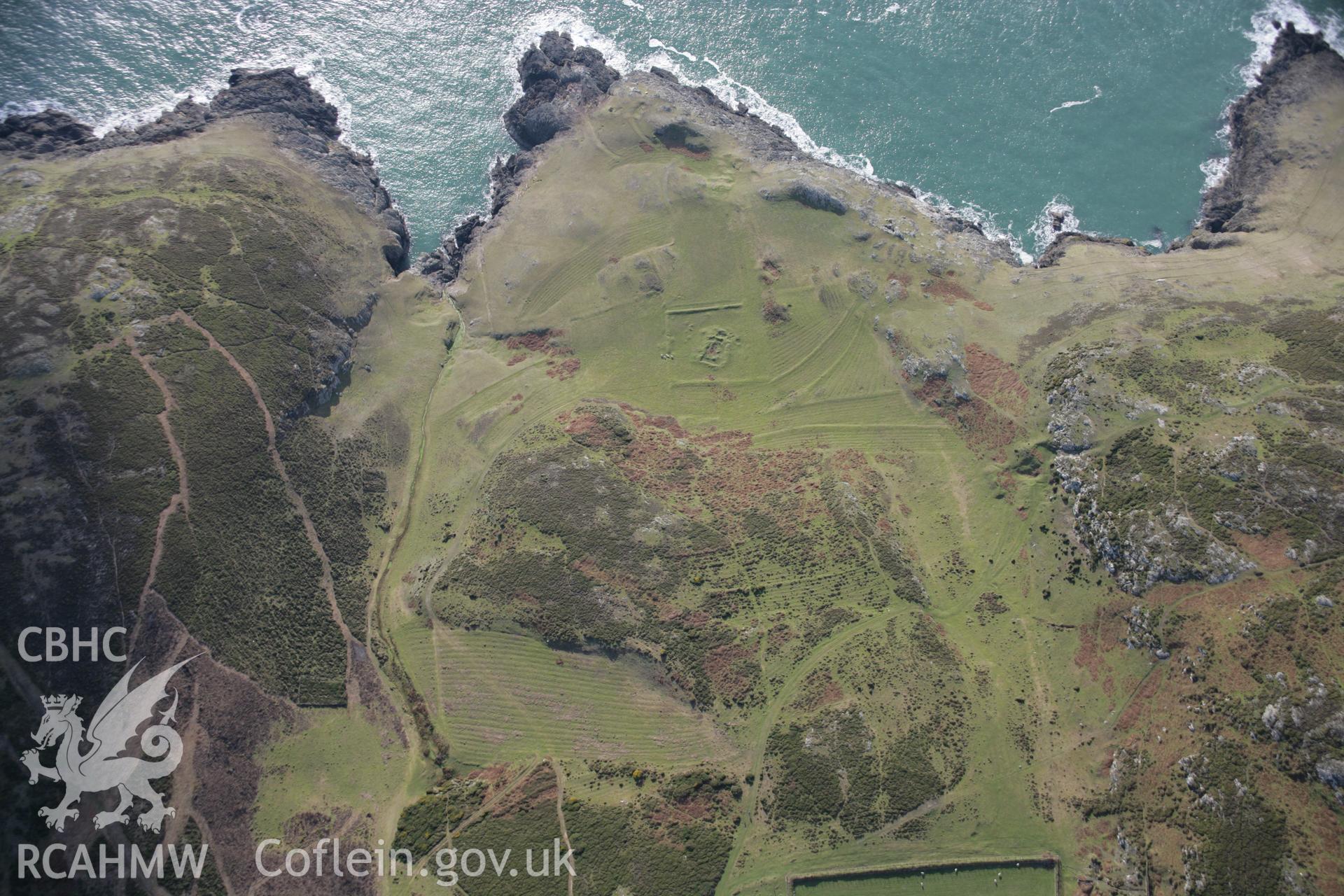 RCAHMW colour oblique aerial photograph of St Marys Church earthworks, viewed from the north-east. Taken on 09 February 2006 by Toby Driver