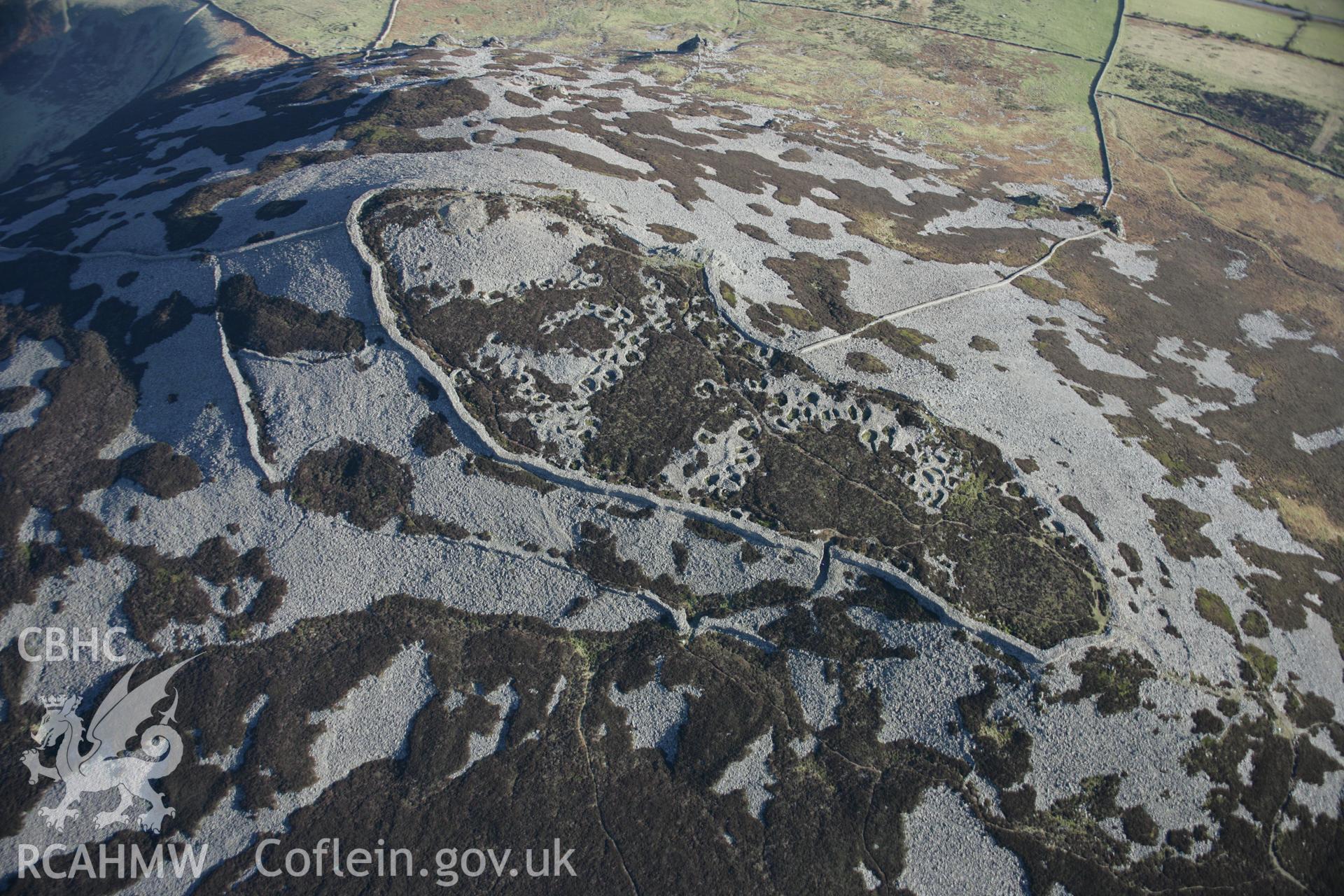 RCAHMW colour oblique aerial photograph of Tre'r Ceiri Fort, Llanaelhaearn from the north-west. Taken on 09 February 2006 by Toby Driver.