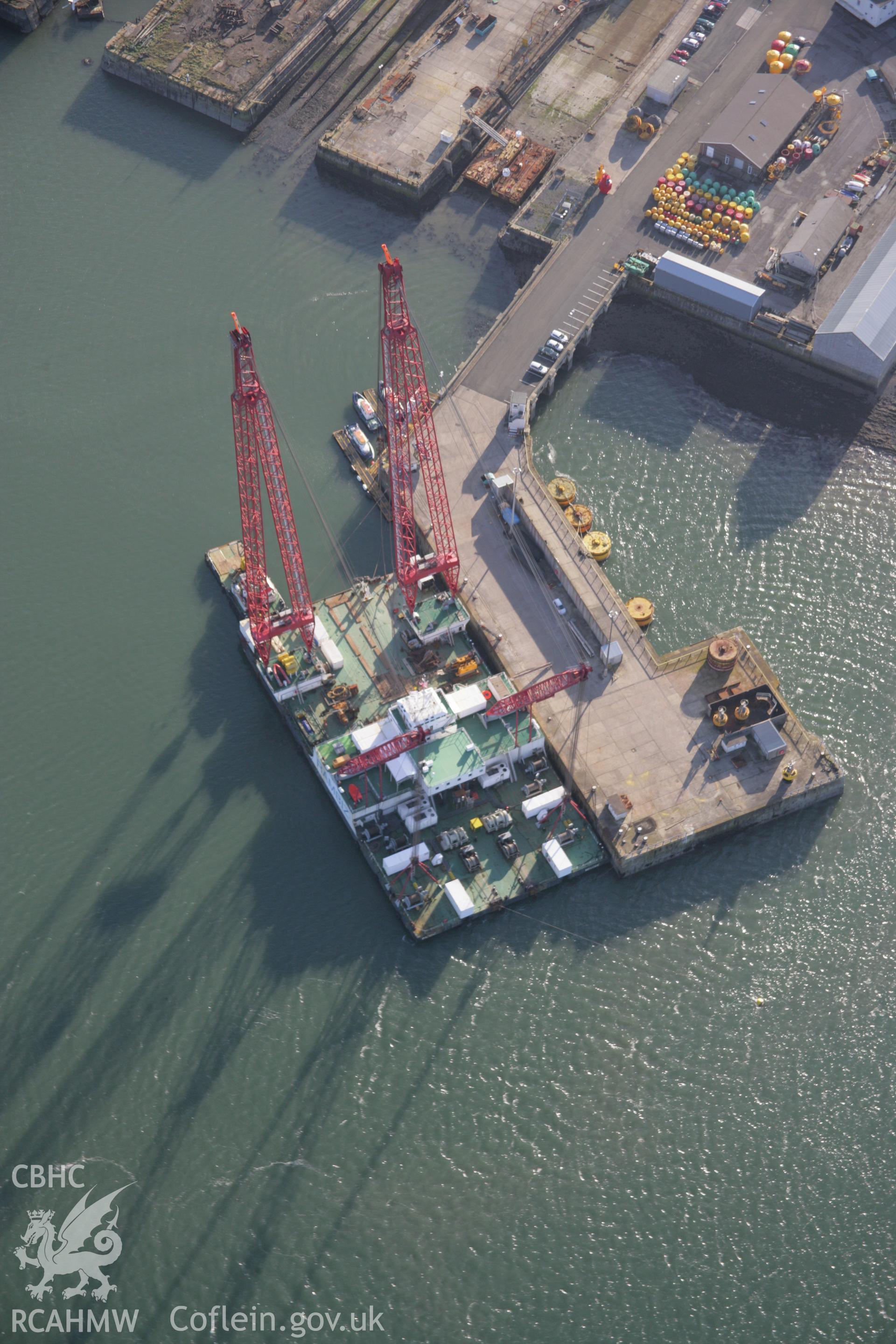 RCAHMW colour oblique aerial photograph of Pembroke Dock, showing large crane tied up, viewed from the north-west. Taken on 11 January 2006 by Toby Driver.