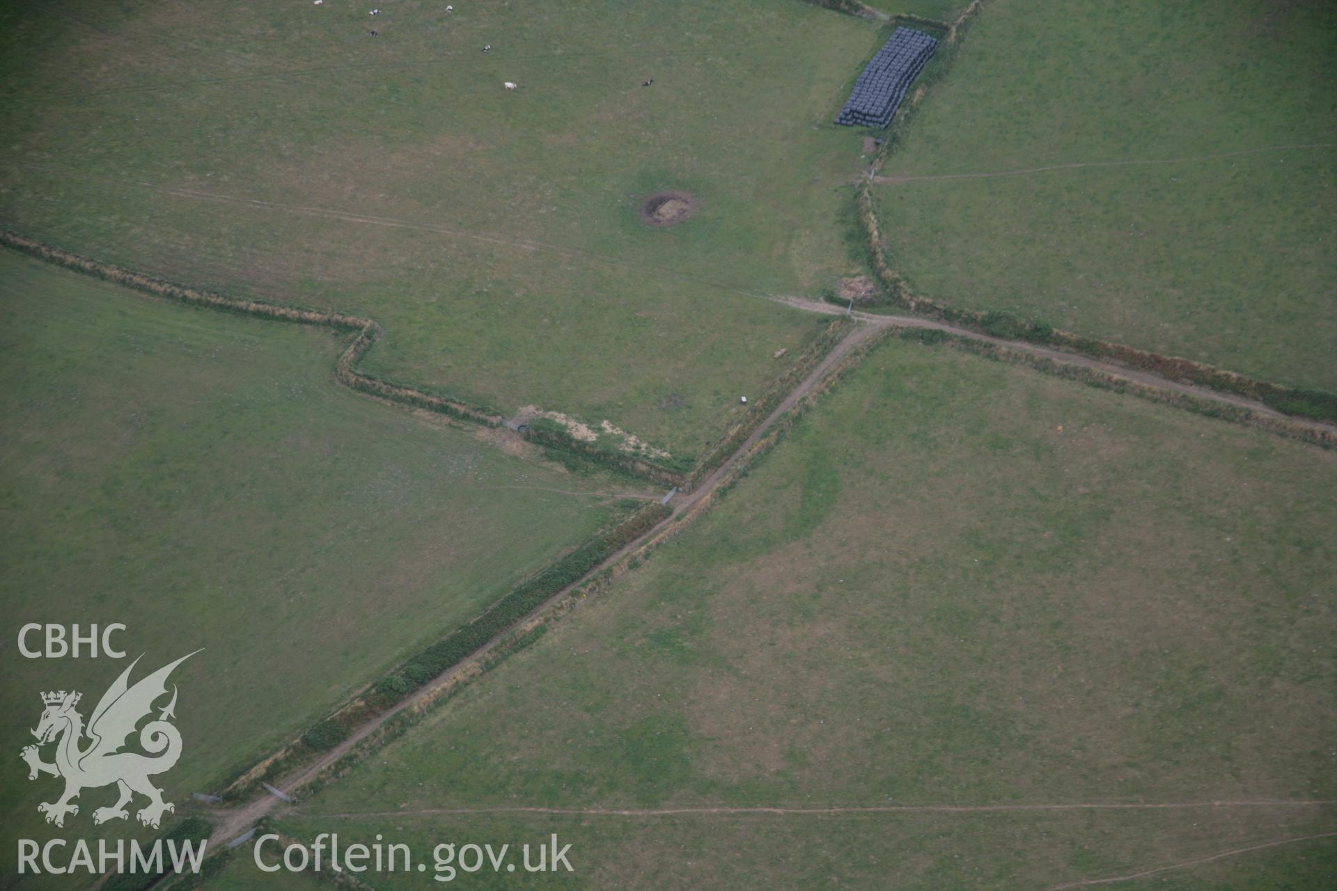 RCAHMW colour oblique aerial photograph of the cropmarks of an enclosure at Cwmistir Uchaf. Taken on 03 August 2006 by Toby Driver.
