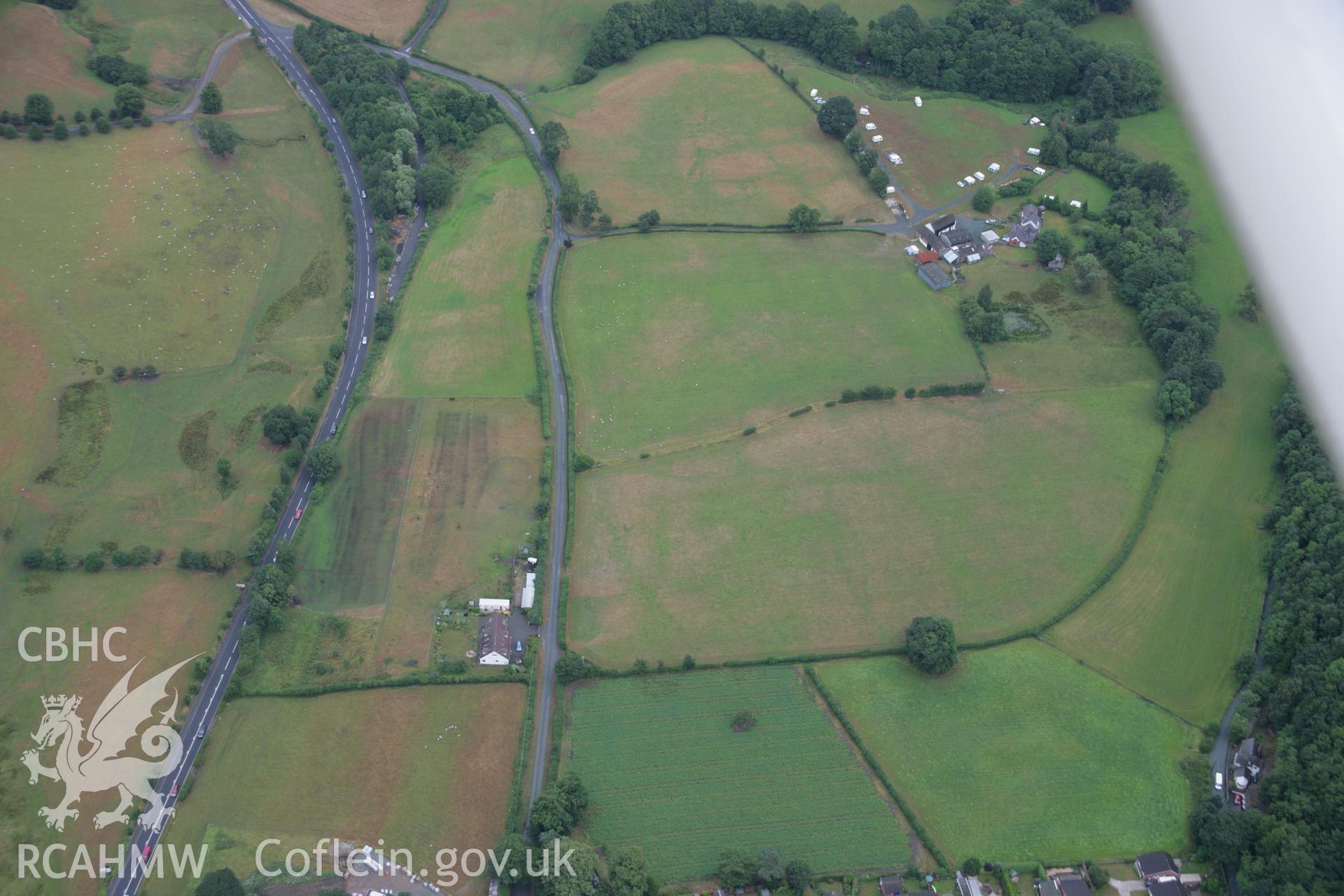 RCAHMW colour oblique aerial photograph showing geological cropmarks to the west of Ty-UchafTy-Uchaf, Llangollen. Taken on 31 July 2006 by Toby Driver