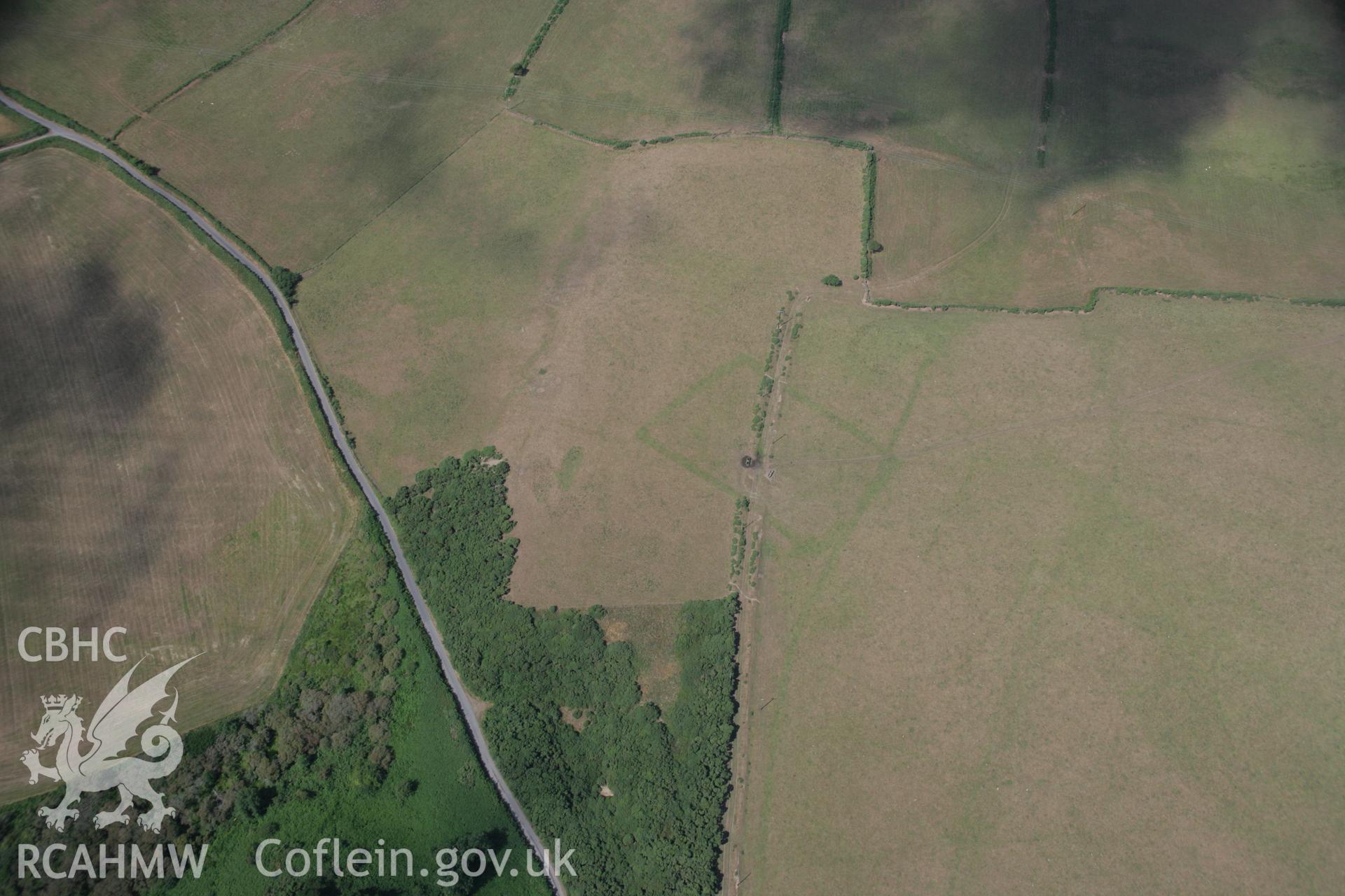 RCAHMW colour oblique aerial photograph of a cropmark Enclosure southeast of Traian, Boduan viewed from the south-east. Taken on 03 August 2006 by Toby Driver.