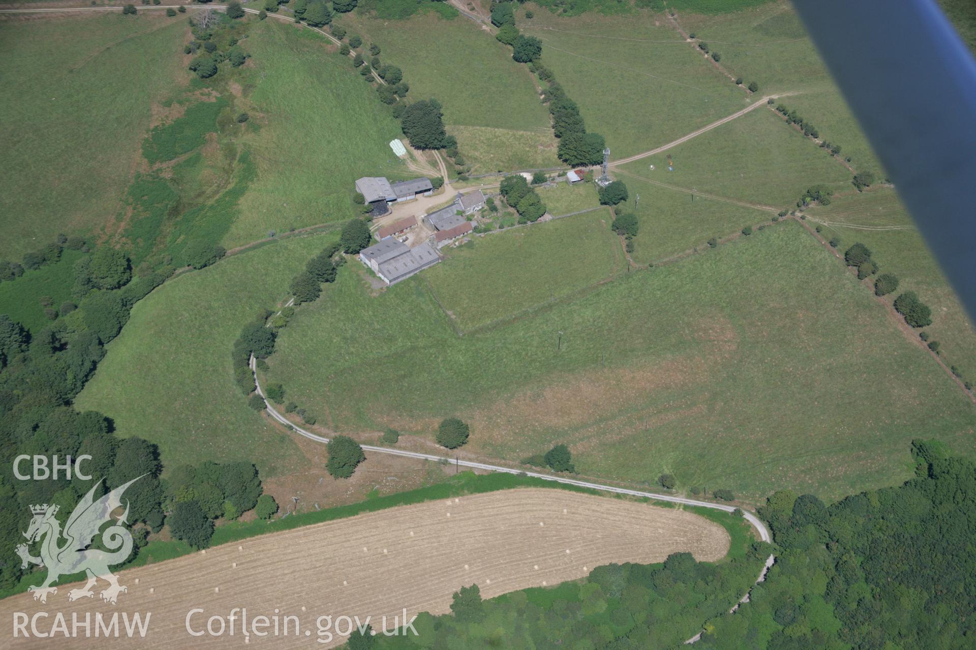 RCAHMW colour oblique aerial photograph of Ton Mawr Farm, showing earthworks that may be an indication of a hillfort. Taken on 24 July 2006 by Toby Driver.