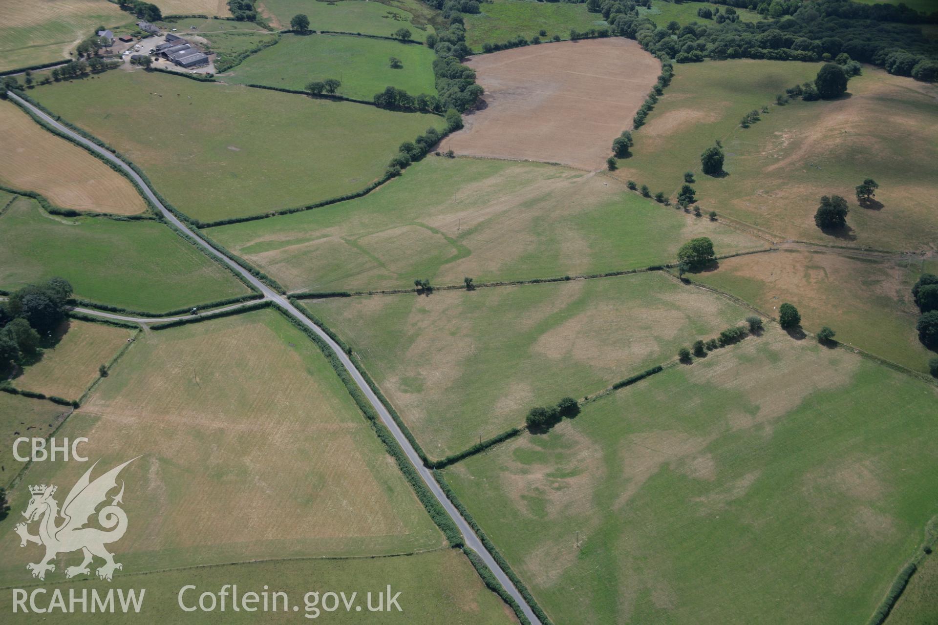 RCAHMW colour oblique aerial photograph of cropmark enclosures west of Caerau. Taken on 27 July 2006 by Toby Driver.