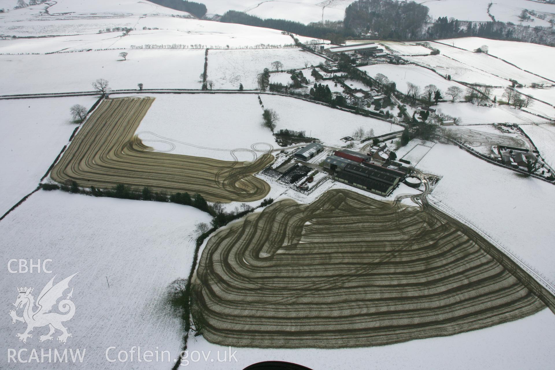 RCAHMW colour oblique aerial photograph of Llidiart-Fawr Farm, with slurry spreading on winter fields. Taken on 06 March 2006 by Toby Driver.