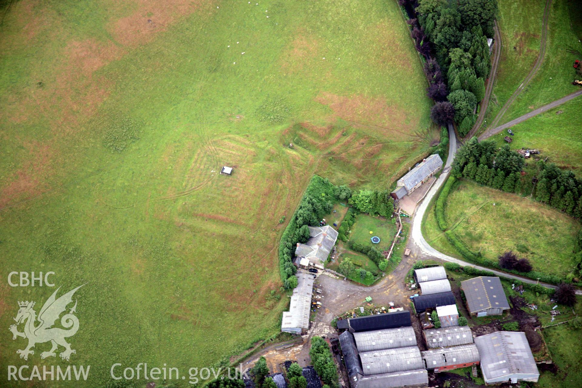 RCAHMW colour oblique aerial photograph of Llwydiarth Hall, Llanfihangel Yng Ngwynfa showing turf maze and garden earthworks. Taken on 31 July 2006 by Toby Driver.
