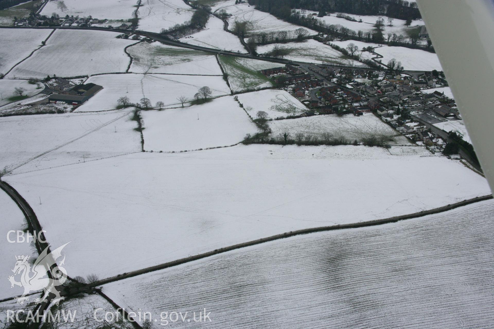RCAHMW colour oblique aerial photograph of Rhewl Round Barrows from the north-east. Taken on 06 March 2006 by Toby Driver.