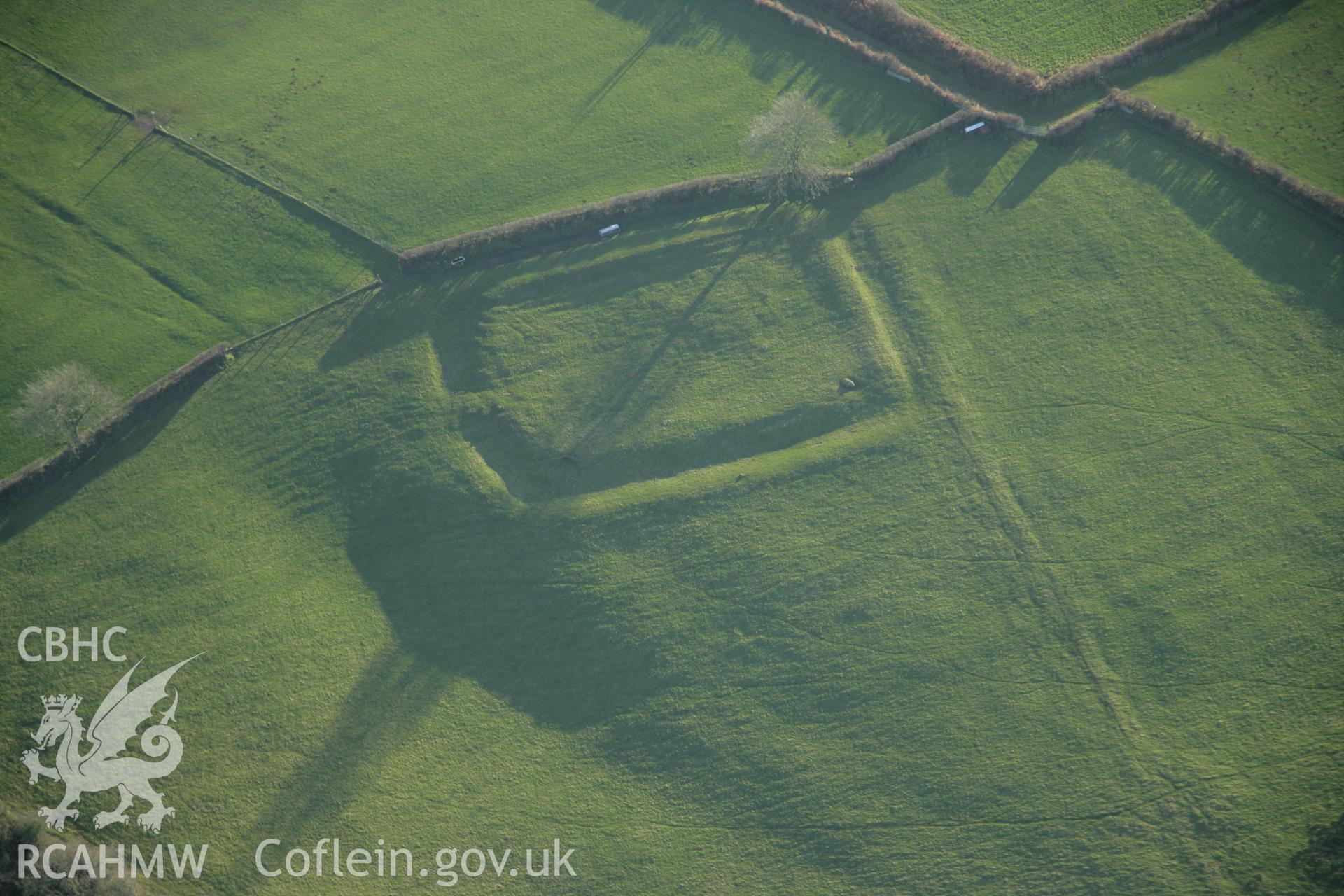 RCAHMW colour oblique aerial photograph of Bryn Cywyn (Llangynog II) Earthwork Enclosure from the north-west. Taken on 26 January 2006 by Toby Driver.