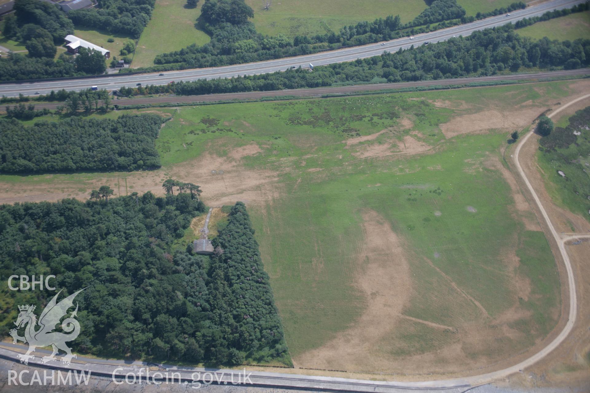 RCAHMW colour oblique aerial photograph of various cropmarks near Bryn-y-Neuadd Garden, Llanfairfechan. Taken on 25 July 2006 by Toby Driver