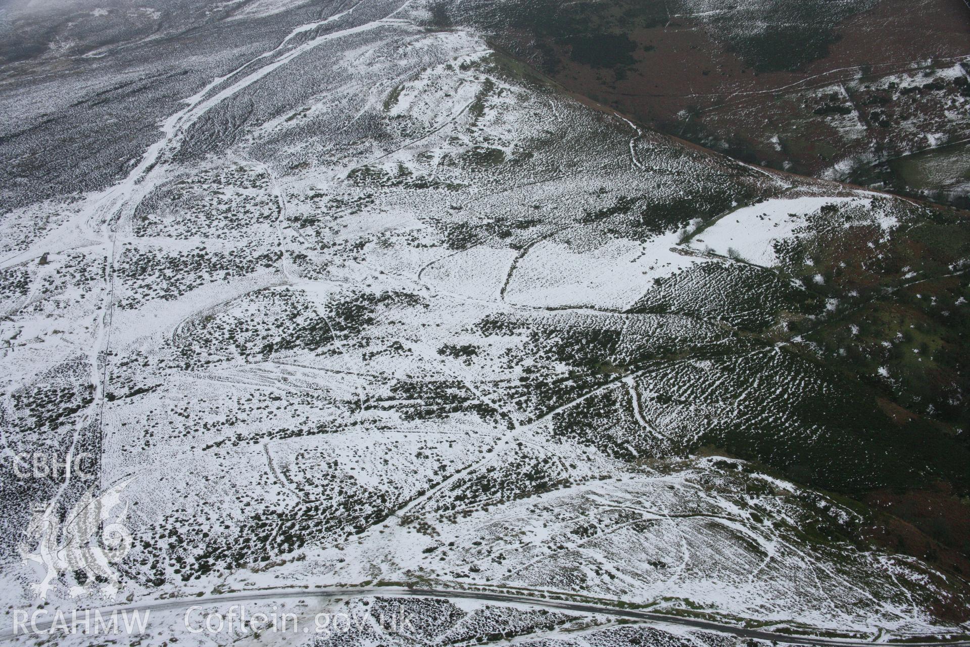 RCAHMW colour oblique aerial photograph showing old field boundaries near Moel-y-Faen Slate Quarries. Taken on 06 March 2006 by Toby Driver