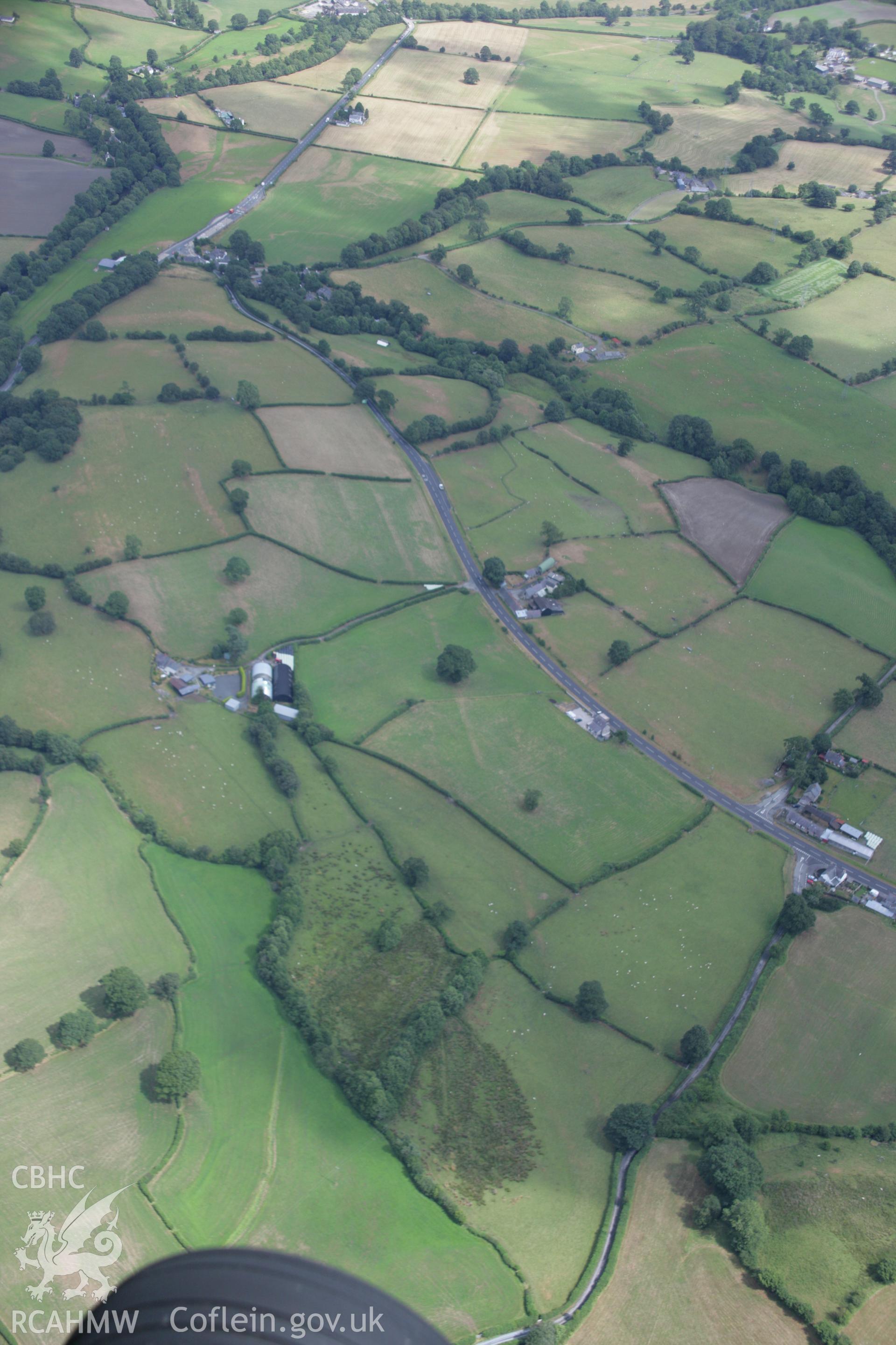 RCAHMW colour oblique aerial photograph of the Roman road between Four Crosses and Druid at Bryncoch. Taken on 31 July 2006 by Toby Driver.