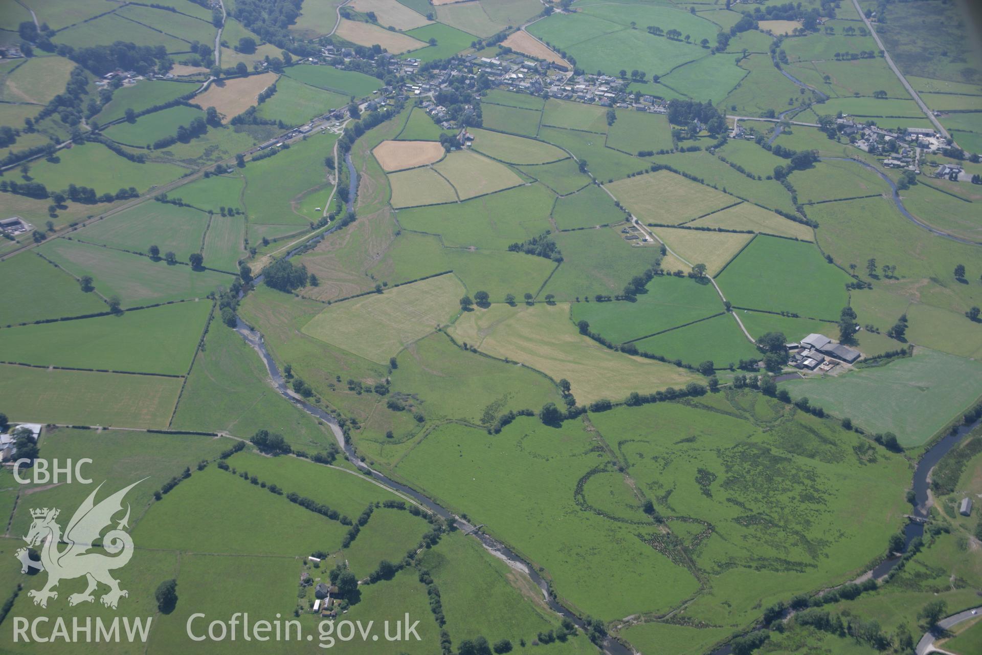 RCAHMW colour oblique aerial photograph of Dolfawr showing the possible cropmarks of a Roman road. Taken on 18 July 2006 by Toby Driver