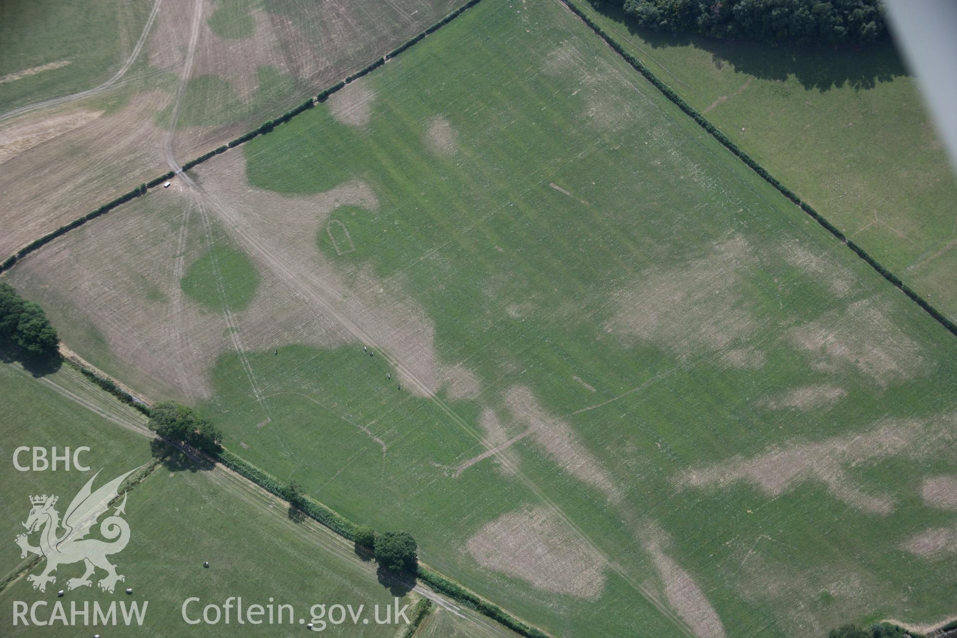 RCAHMW colour oblique aerial photograph of Llwydfaen Medieval Township, general view from north-east with parchmarks of church and building foundations, taken on 14/08/2006 by Toby Driver.
