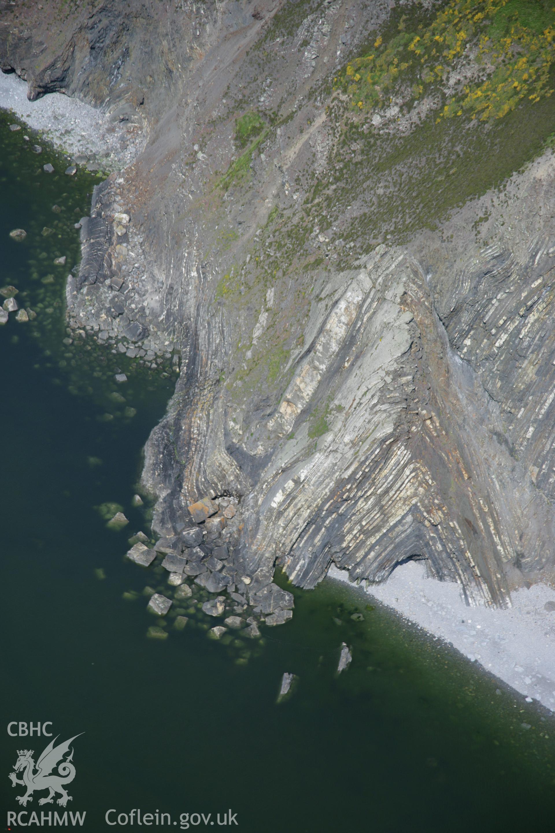 RCAHMW colour oblique aerial photograph of the Pembrokeshire Coast Path between Ceibwr Bay and Foel Hendre, from the south and showing the geology of the area. Taken on 08 June 2006 by Toby Driver.