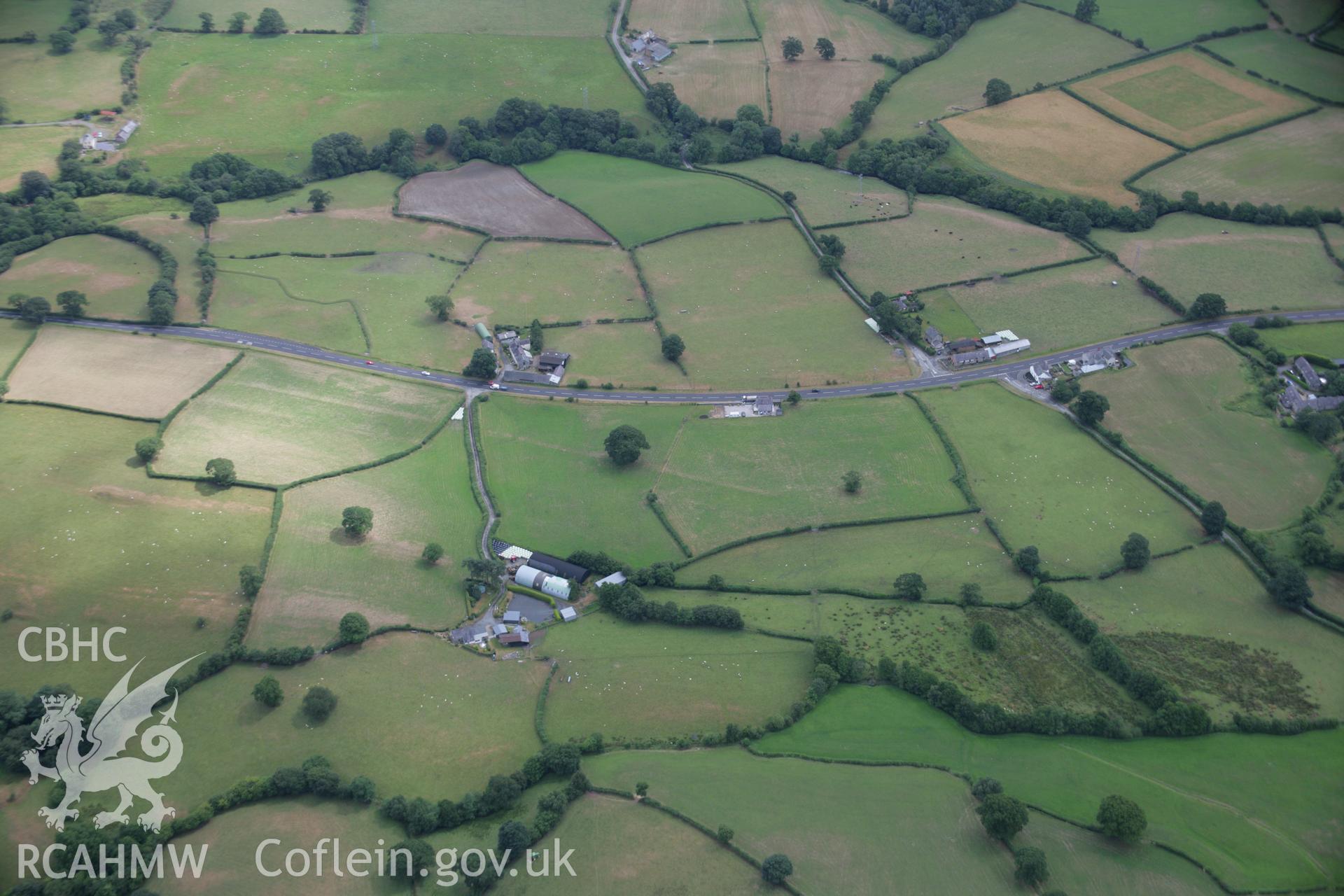 RCAHMW colour oblique aerial photograph of the Roman road between Four Crosses and Druid at Bryncoch. Taken on 31 July 2006 by Toby Driver.