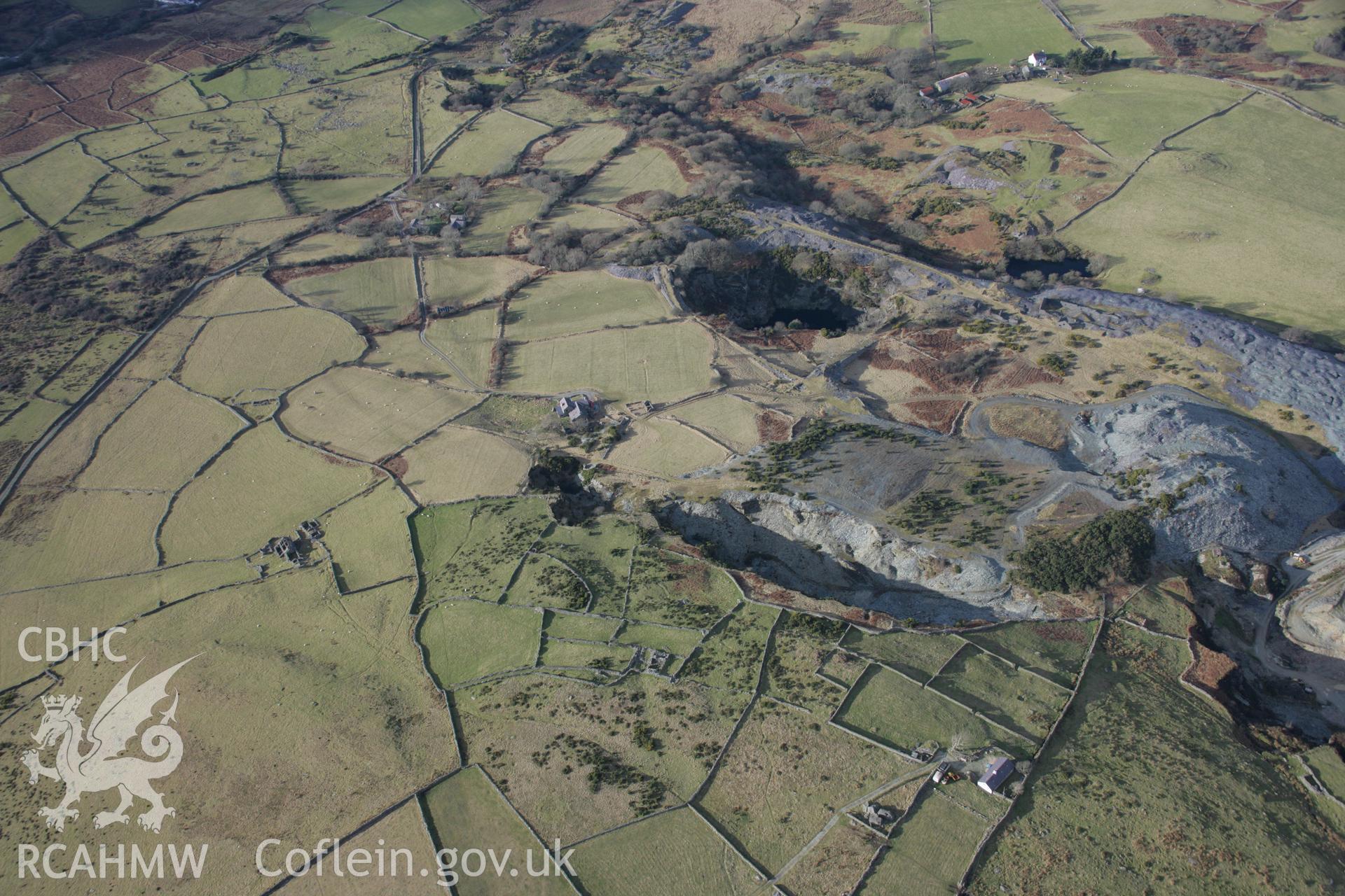 RCAHMW colour oblique aerial photograph of Vronheulog Slate Quarry and nearby field systems from the south-east. Taken on 09 February 2006 by Toby Driver.