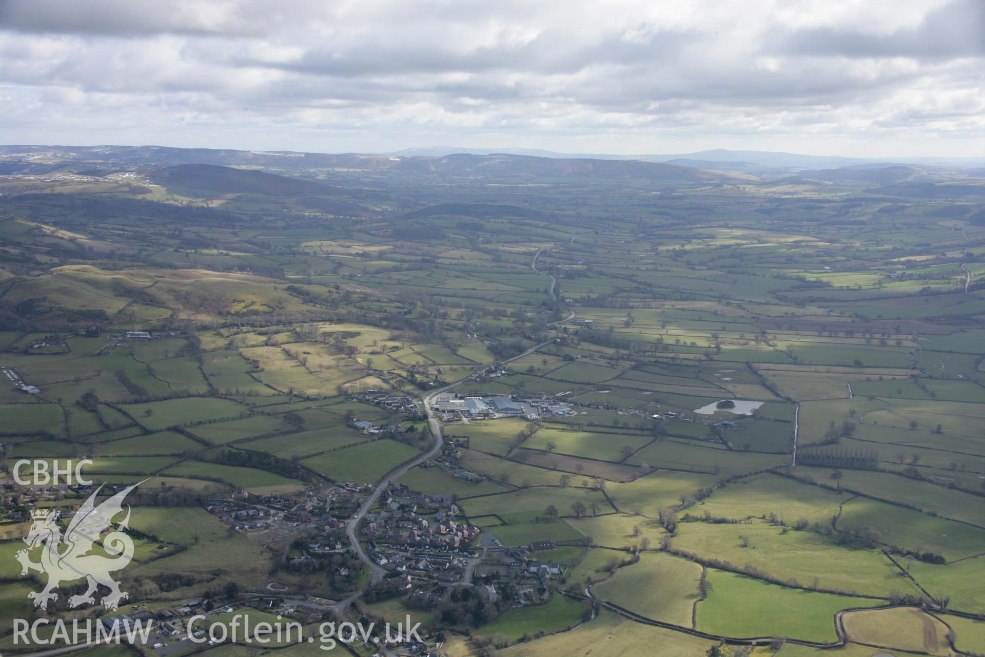 RCAHMW colour oblique aerial photograph of Churchstoke and the surrounding landscape from the north-west. Taken on 06 March 2006 by Toby Driver.