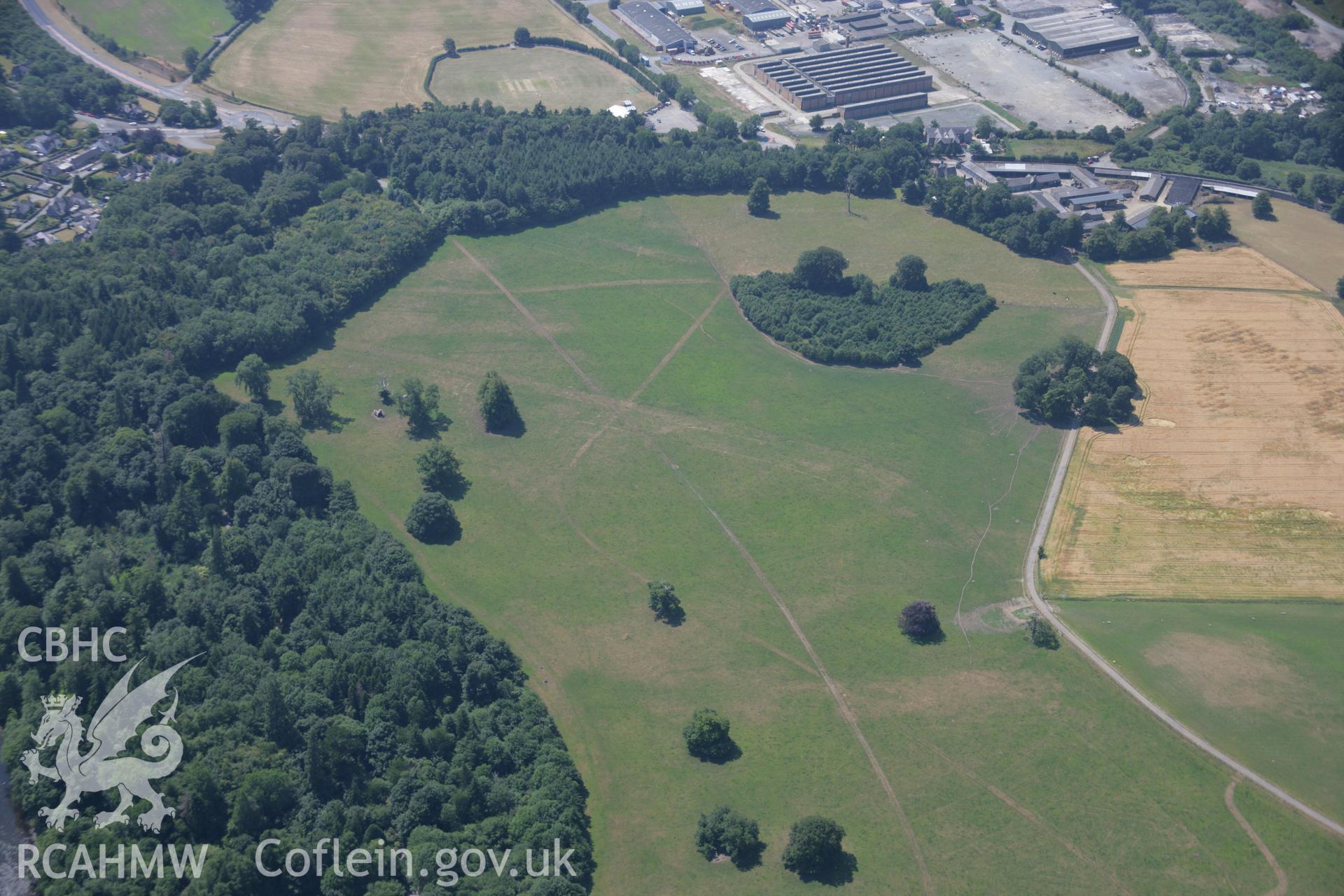 RCAHMW colour oblique aerial photograph of Penryhn Park Earthworks, visible in cropmarks. Taken on 18 July 2006 by Toby Driver.