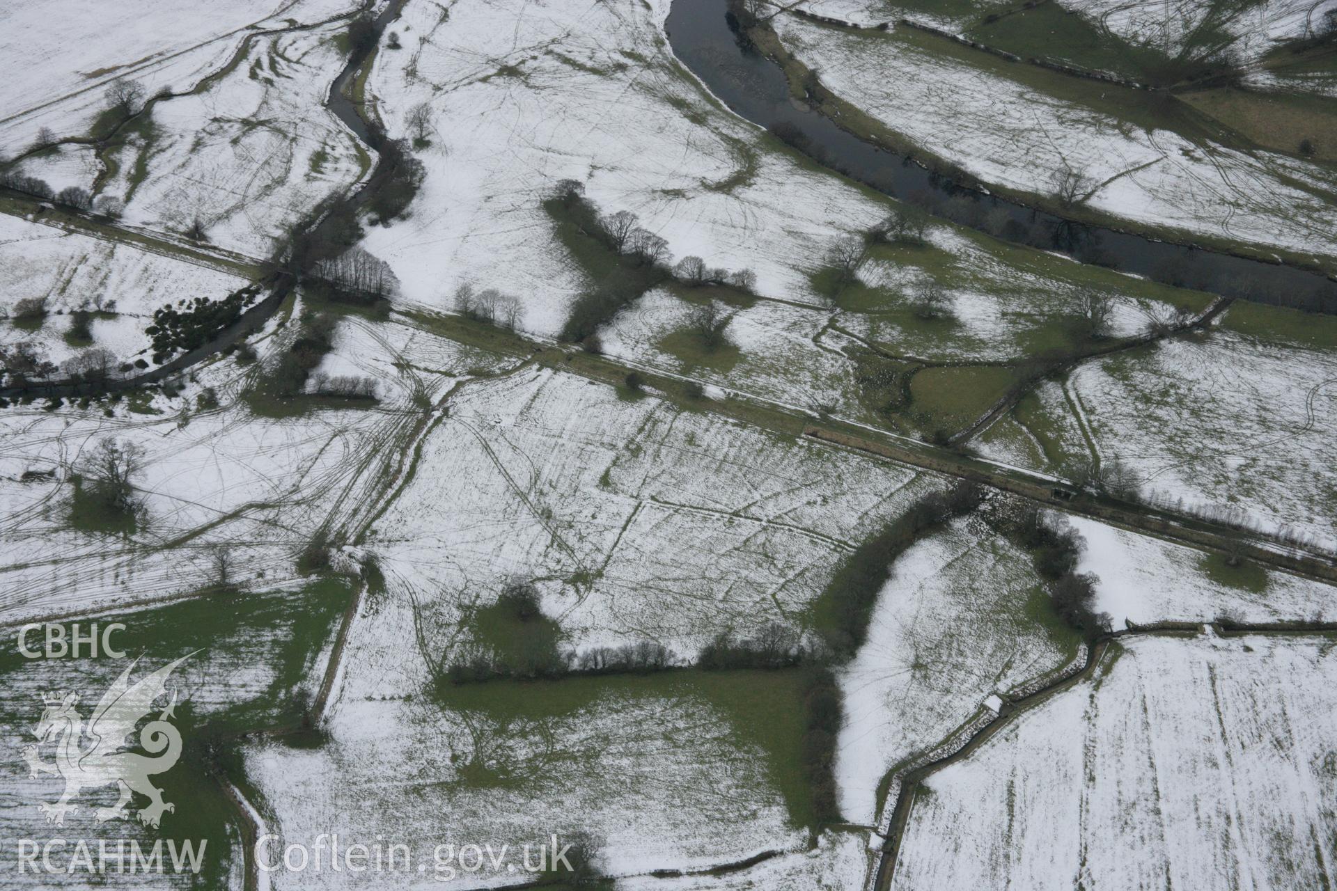 RCAHMW colour oblique aerial photograph of old fields beneath railway embankment to the north of Llandrillo station. Taken on 06 March 2006 by Toby Driver.