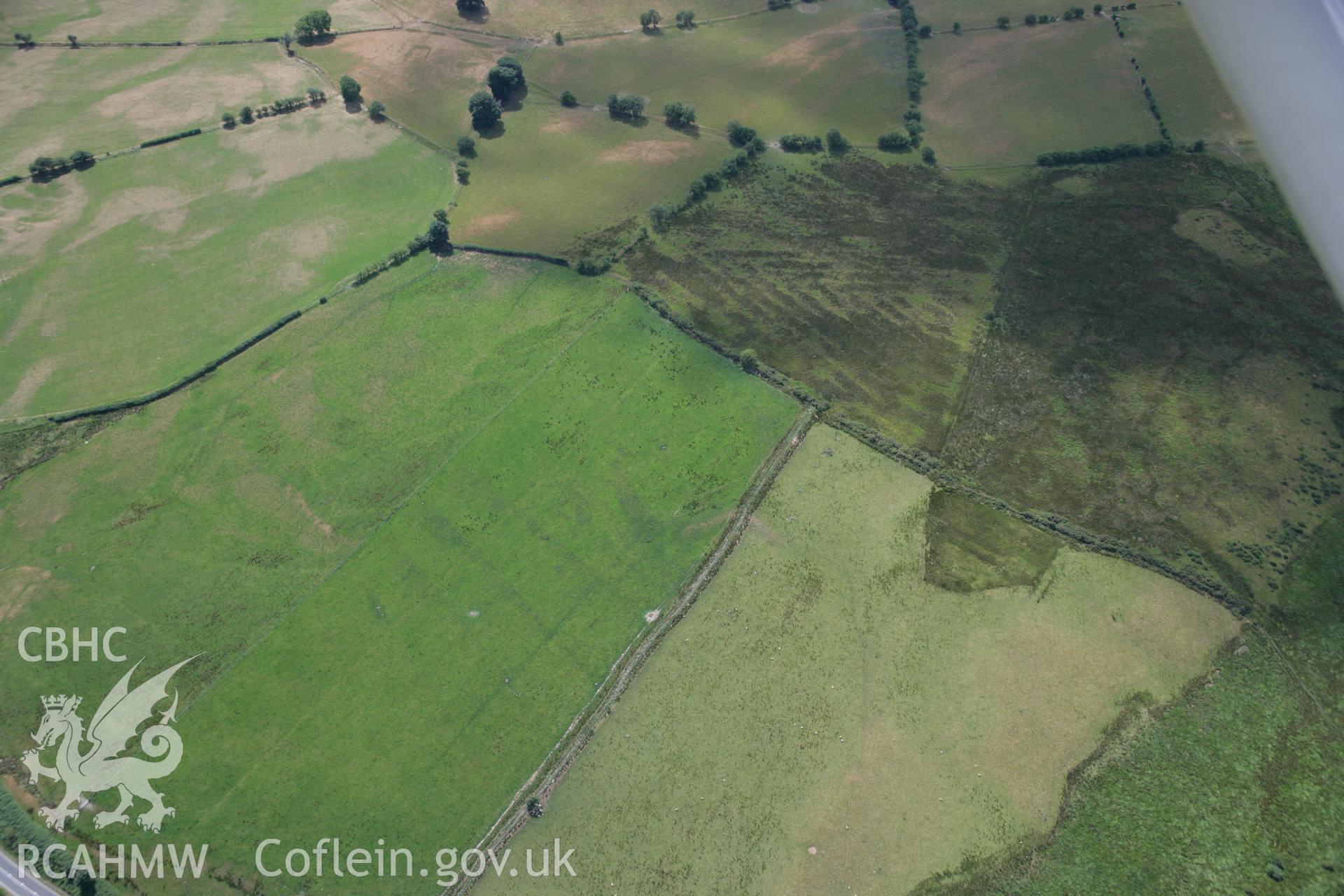 RCAHMW colour oblique aerial photograph of cropmark enclosures to the west of Caerau. Taken on 27 July 2006 by Toby Driver