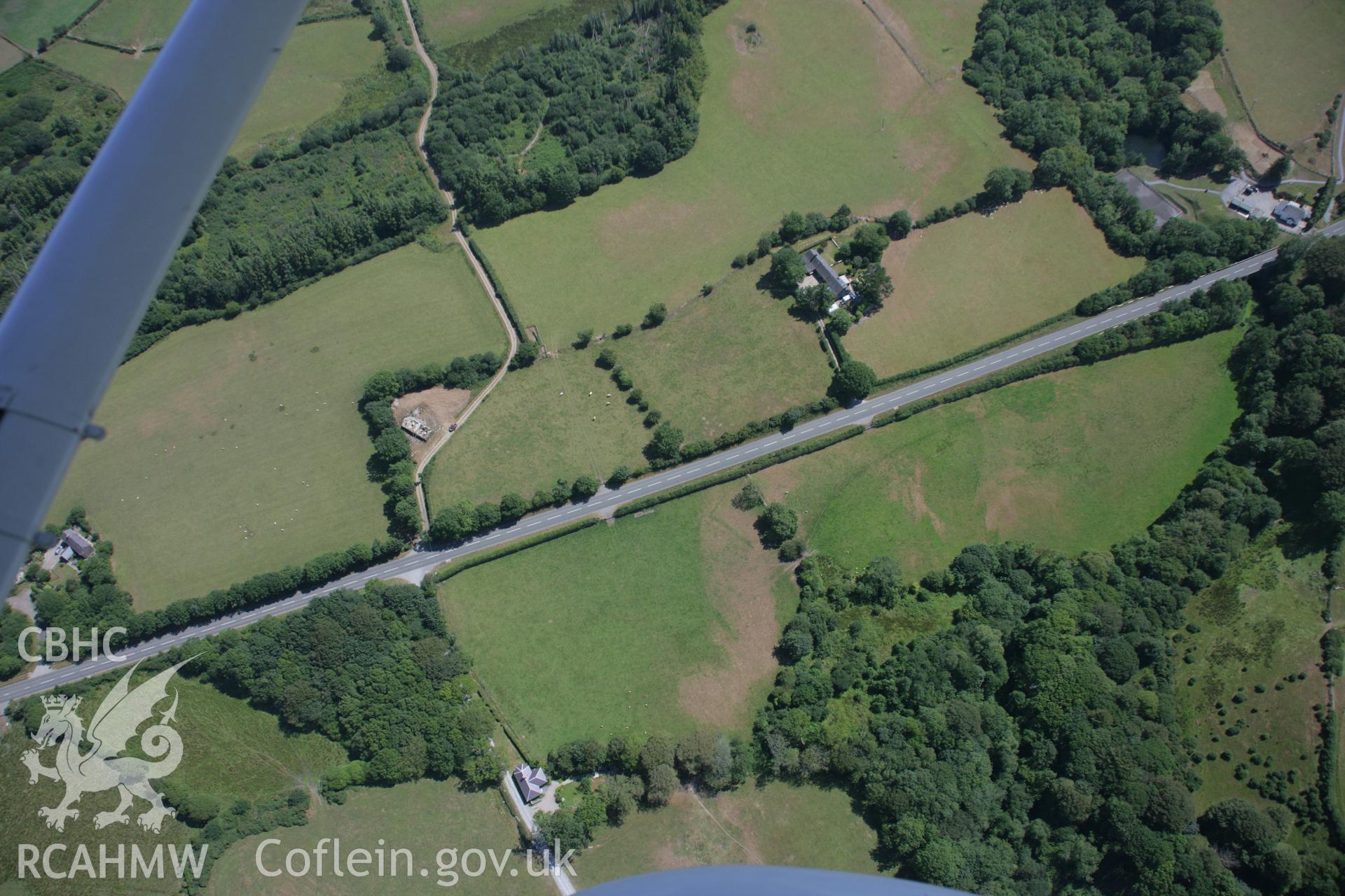 RCAHMW colour oblique aerial photograph of Castell Gwgan cropmarks, probably representing the site of a defended enclosure. Taken on 03 August 2006 by Toby Driver.