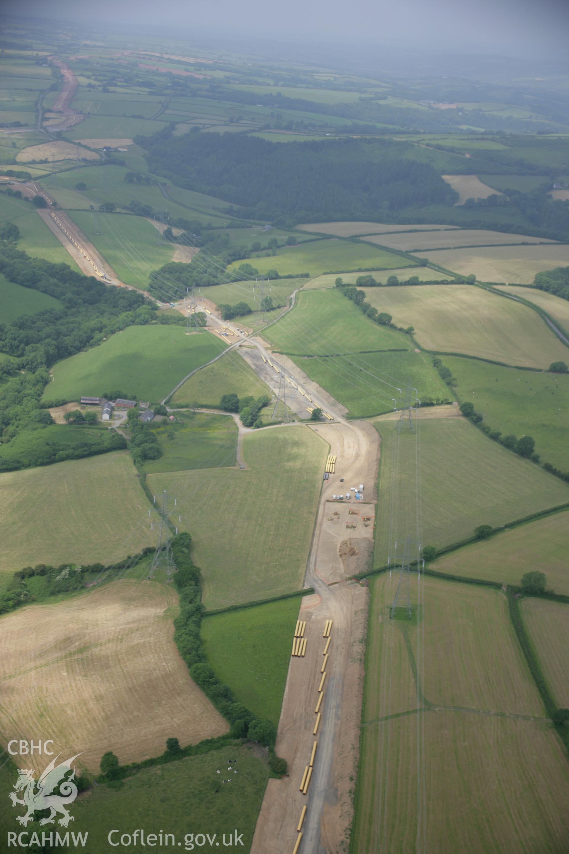 RCAHMW colour oblique aerial photograph of Vaynor Farm Henge showing excavations. A high view looking west. Taken on 15 June 2006 by Toby Driver.