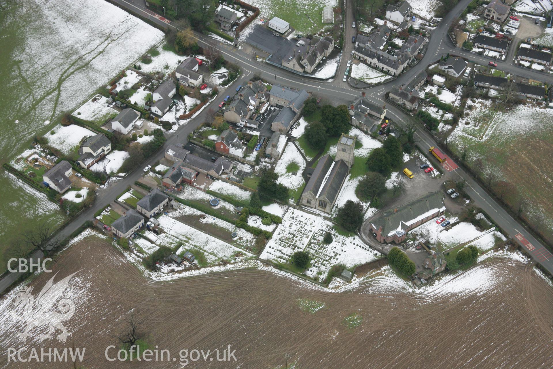 RCAHMW colour oblique aerial photograph of St Cynfarch and St Mary's Church, Llanfair Dyffryn Clwyd, under snow from the north-east. Taken on 06 March 2006 by Toby Driver.