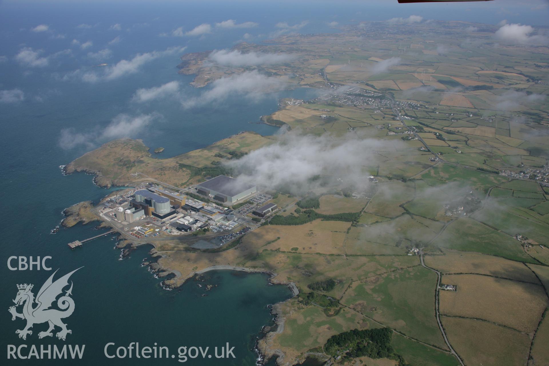 RCAHMW colour oblique aerial photograph of Wylfa Nuclear Power Station. A high landscape view. Taken on 14 August 2006 by Toby Driver.