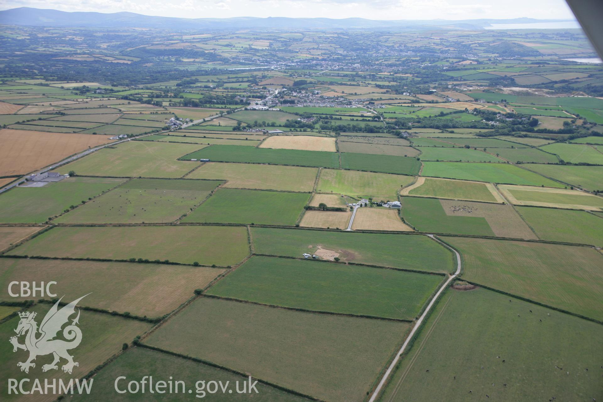 RCAHMW colour oblique aerial photograph of Ffynnonwen Defended Enclosure during excavations by the Dyfed Archaeological Trust. Taken on 27 July 2006 by Toby Driver.