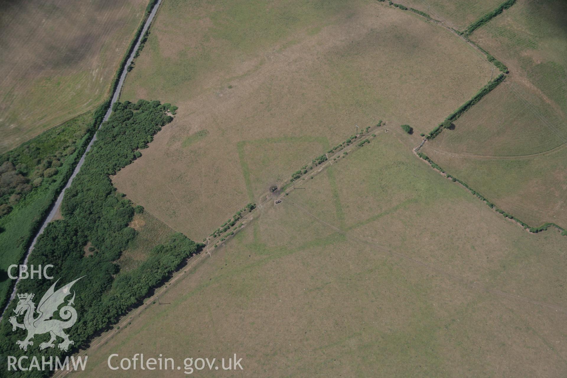 RCAHMW colour oblique aerial photograph of a cropmark Enclosure southeast of Traian, Boduan viewed from the east. Taken on 03 August 2006 by Toby Driver.