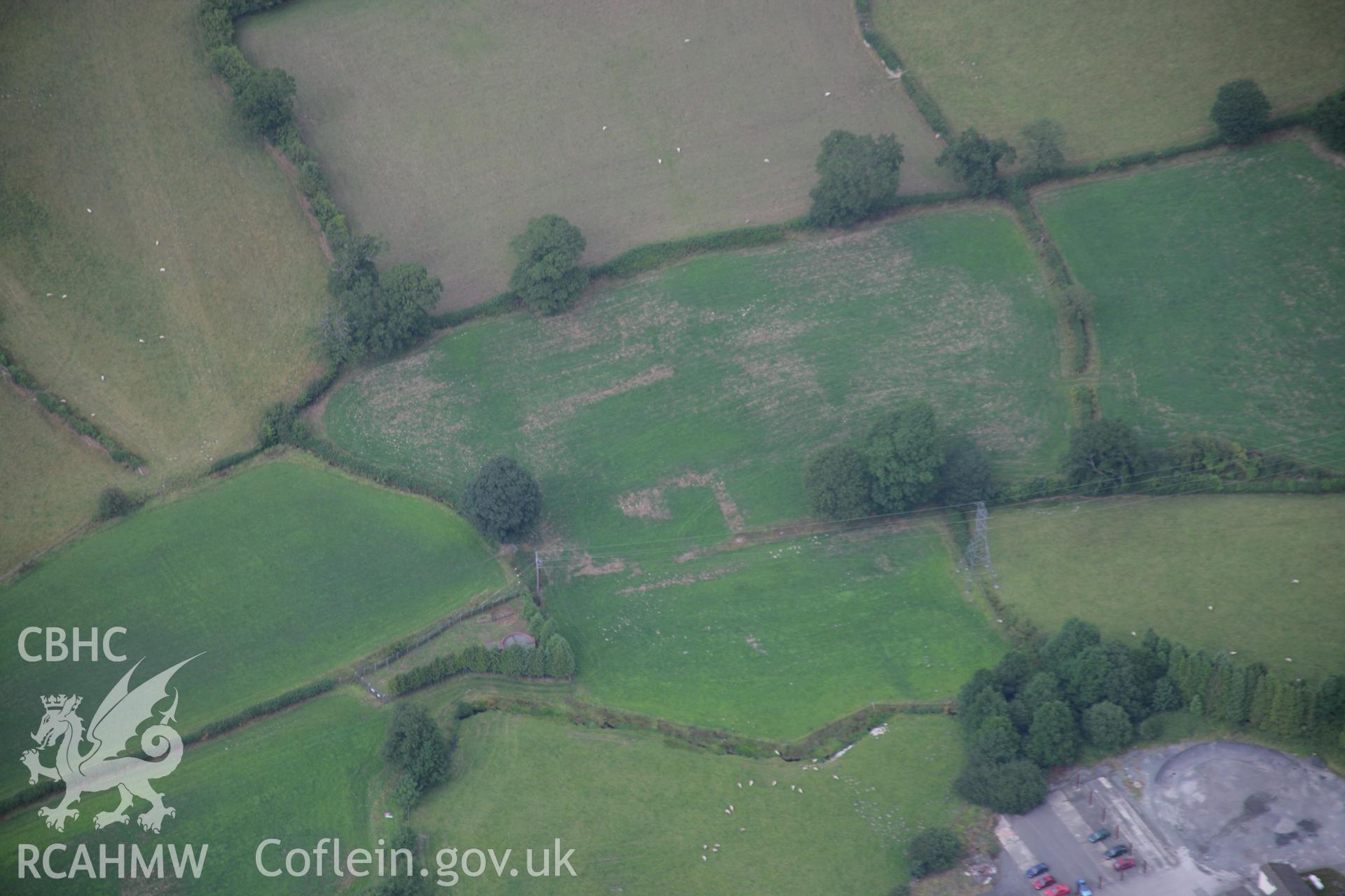 RCAHMW colour oblique aerial photograph of St James' Church, showing uncertain cropmarks. Taken on 14 August 2006 by Toby Driver
