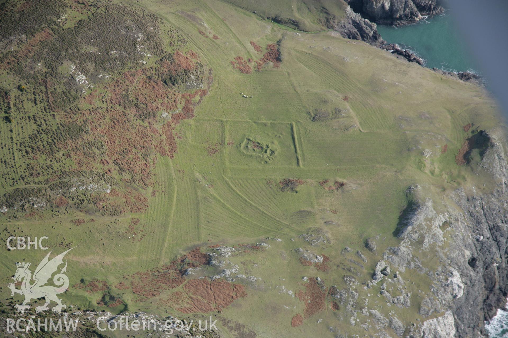 RCAHMW colour oblique aerial photograph of St Marys Church earthworks, viewed from the north-west. Taken on 09 February 2006 by Toby Driver